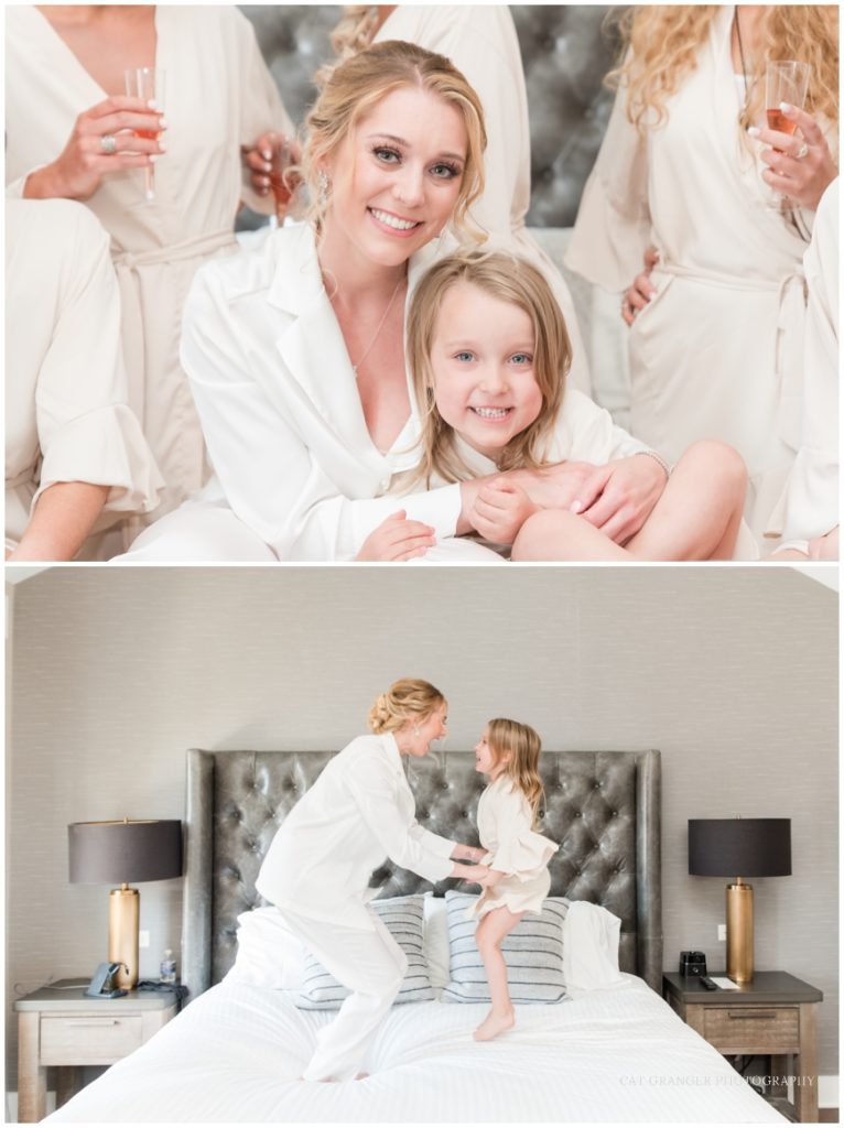 Bride and flower girl jumping in bed