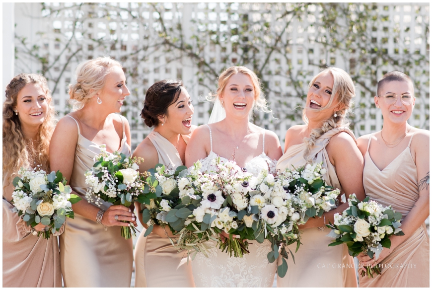 bride and bridesmaids laughing portrait