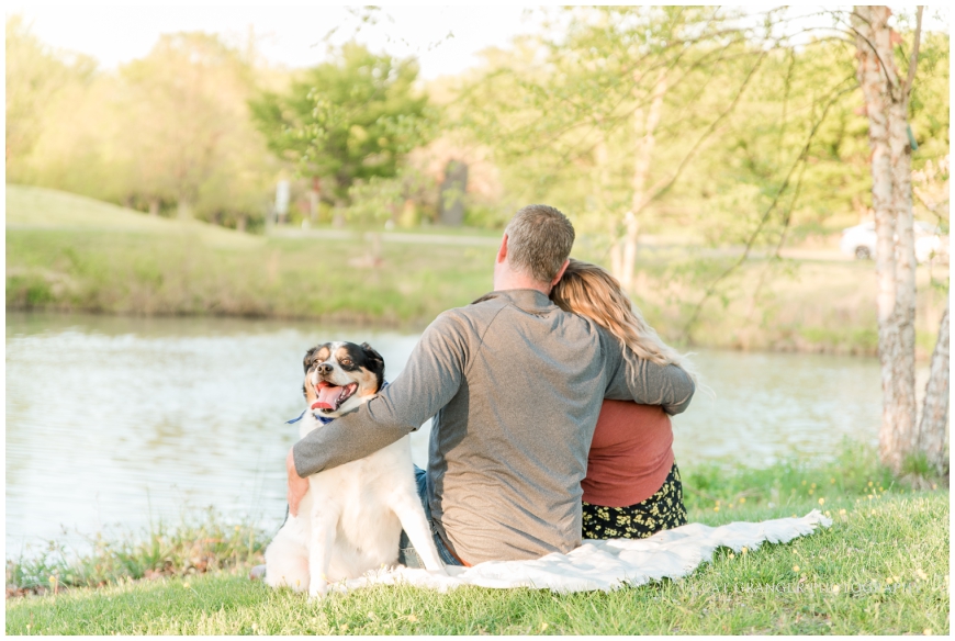 couple and dog overlooking river