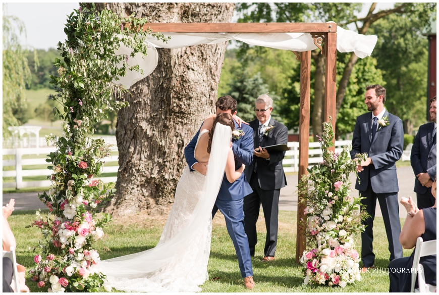 wedding ceremony at oak tree bluebird manor dip kiss