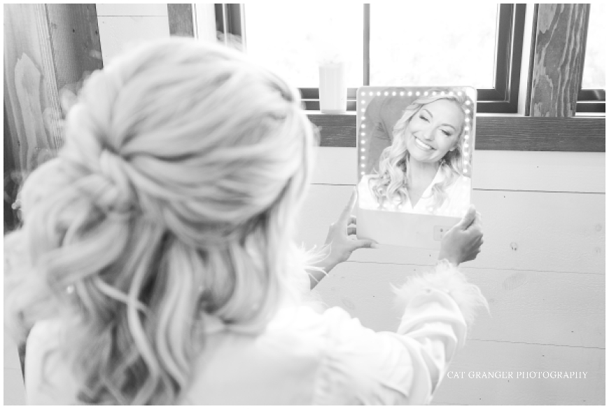 bride looking in the mirror on wedding day