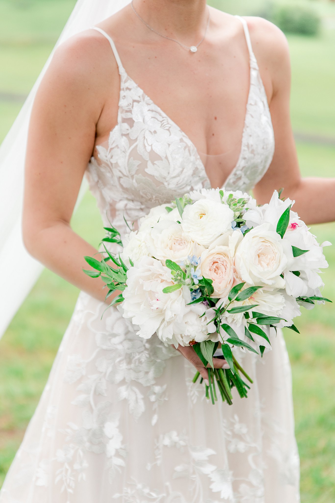Details of a bride's white and pink bouquet in her hand