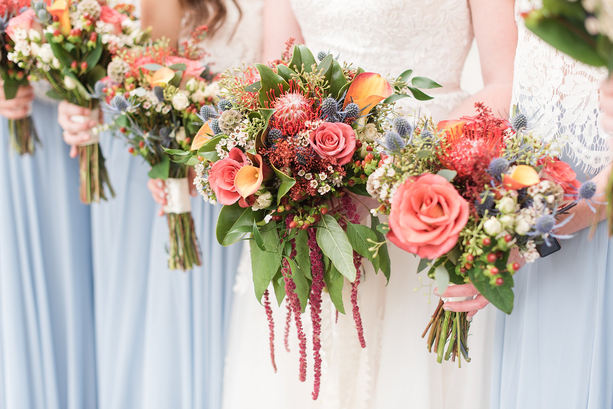 Details of a colorful and vibrant bridal bouquet with the bridesmaids at a Belmont Manor Wedding