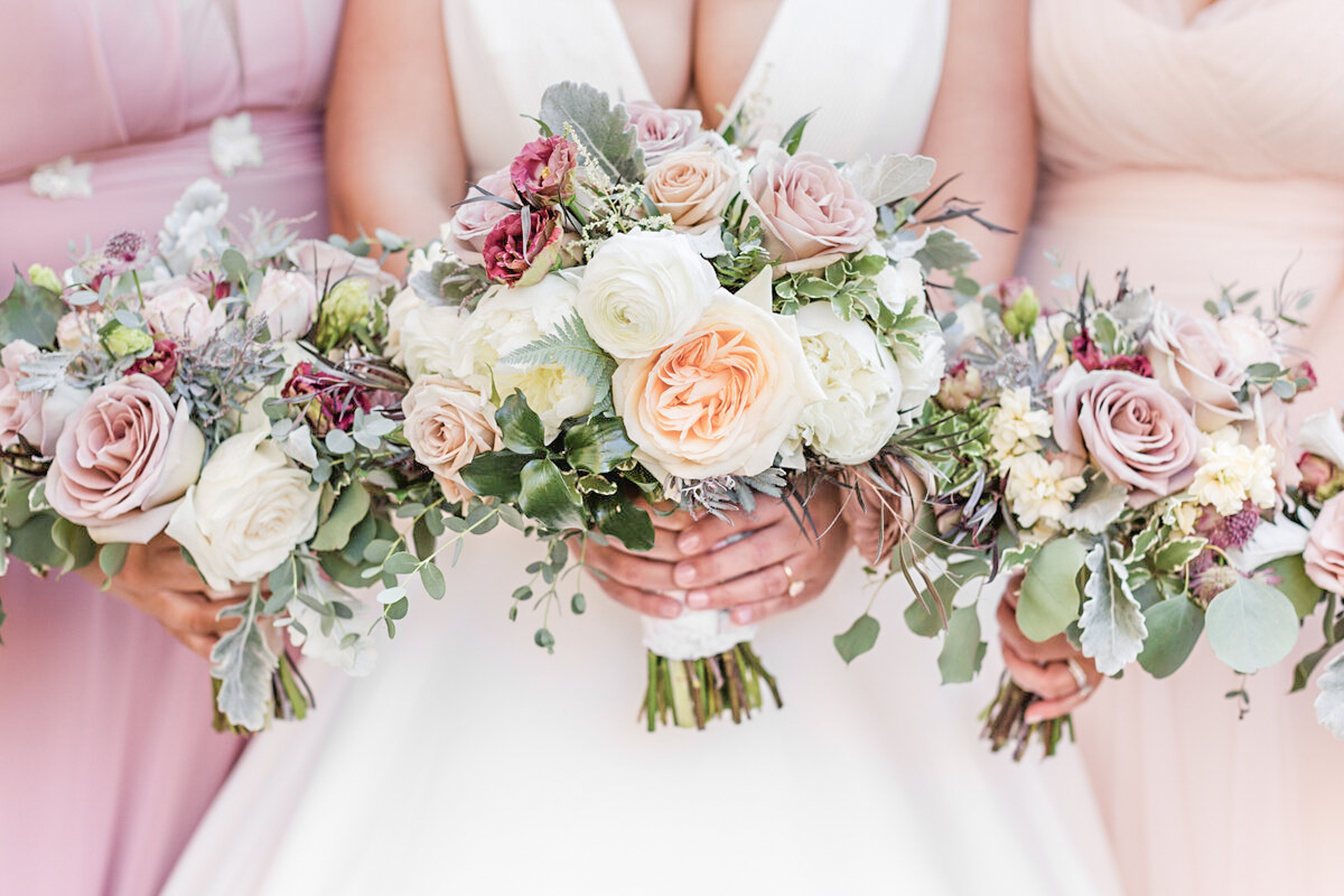 Details of a bride's bouquet with her bridesmaid's