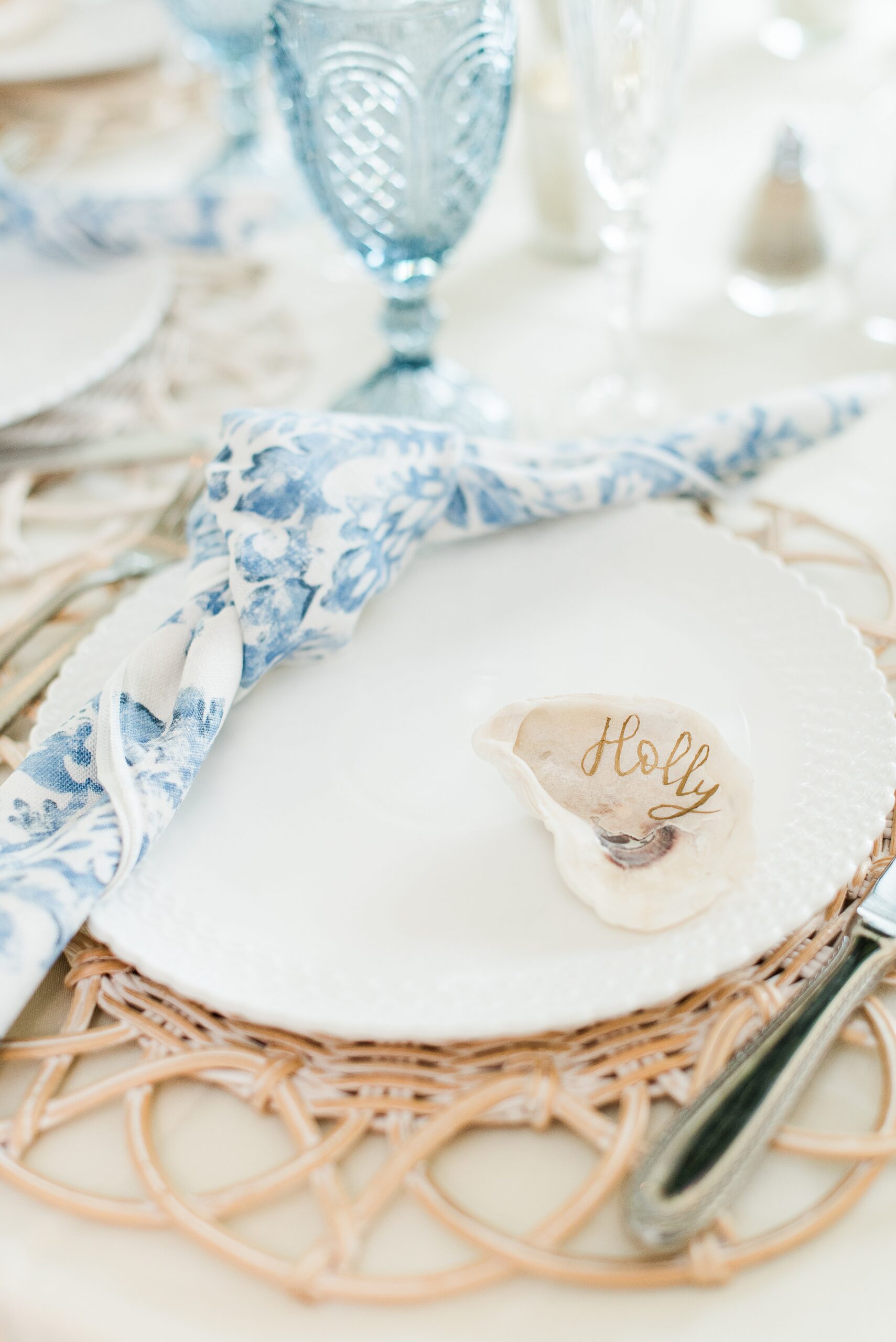 Details of a wedding reception place setting with shell name cards