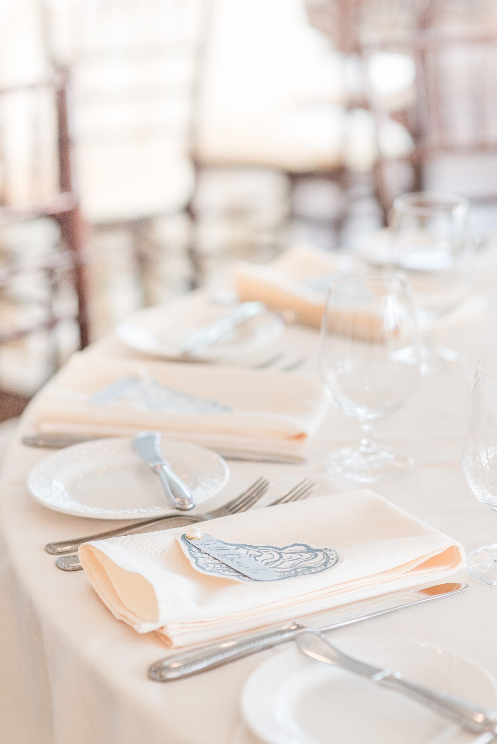 Details of a wedding reception place setting with pink linens