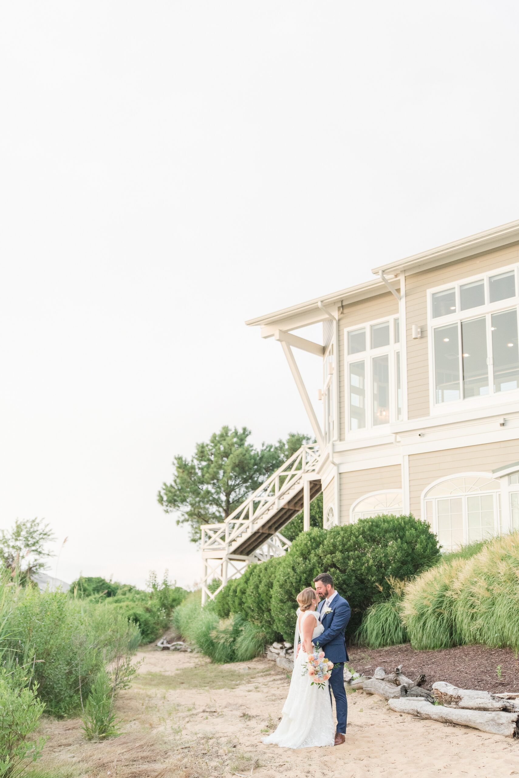 Newlyweds share an intimate moment in the garden outside their venue