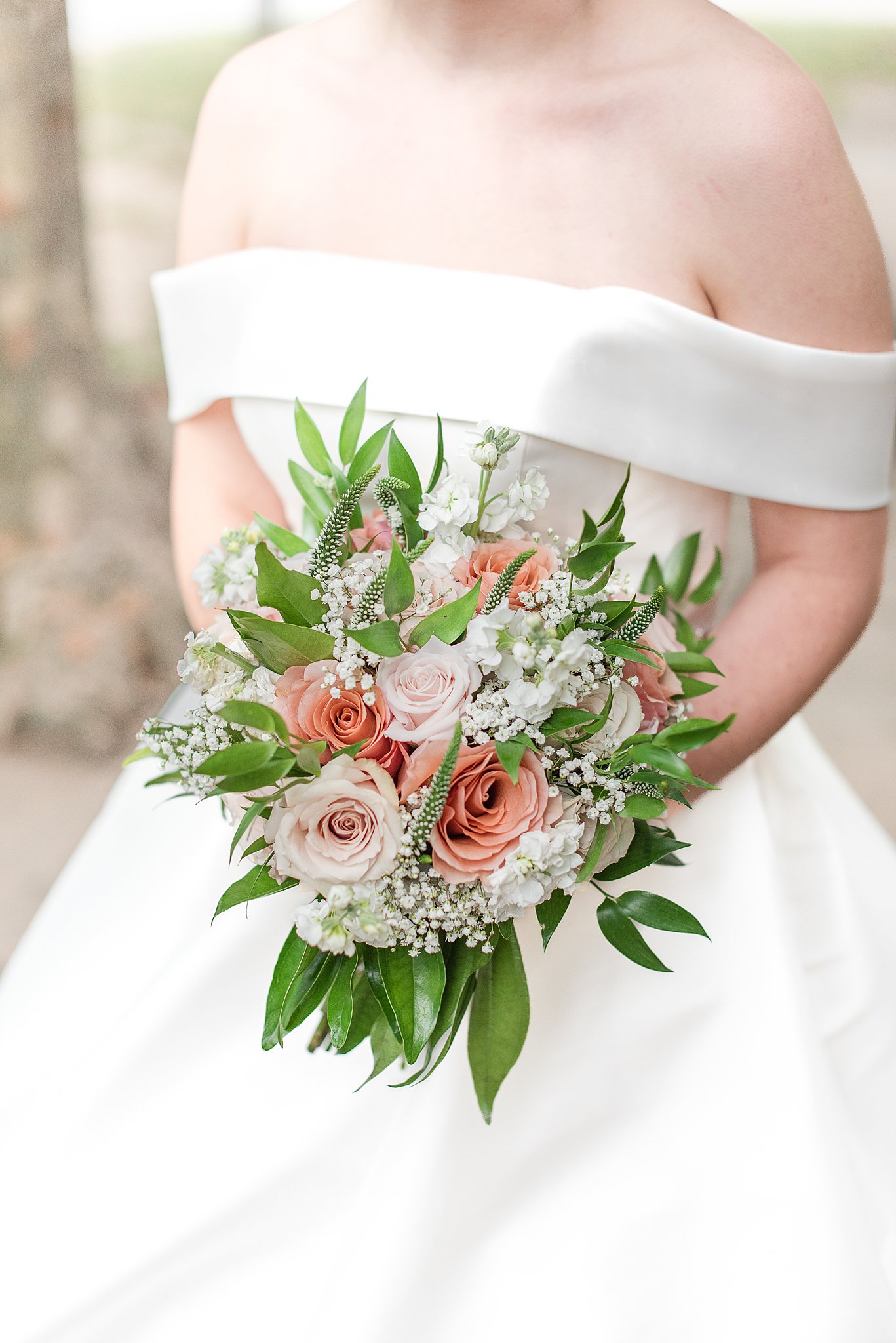 Details of a bride's pink bouquet in her hands