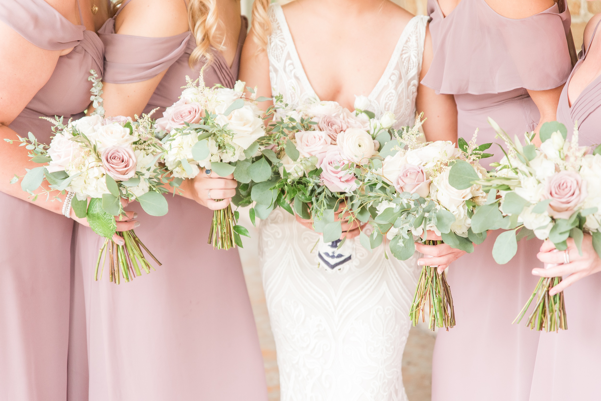 Details of a bride holding her bouquet with her bridesmaids at her 1840s Plaza Wedding