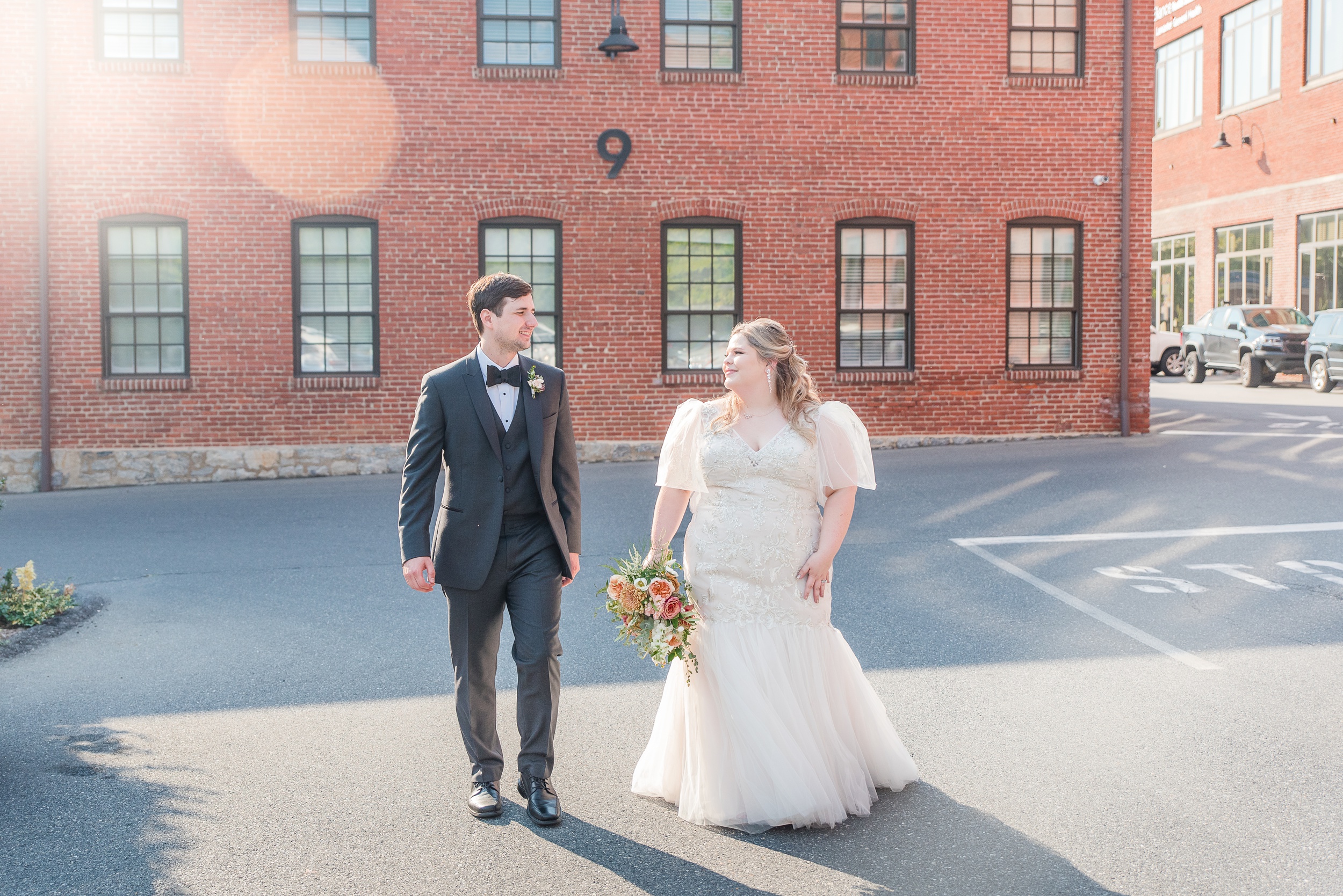 Newlyweds walk together through the parking lot at their Cork Factory Hotel Wedding