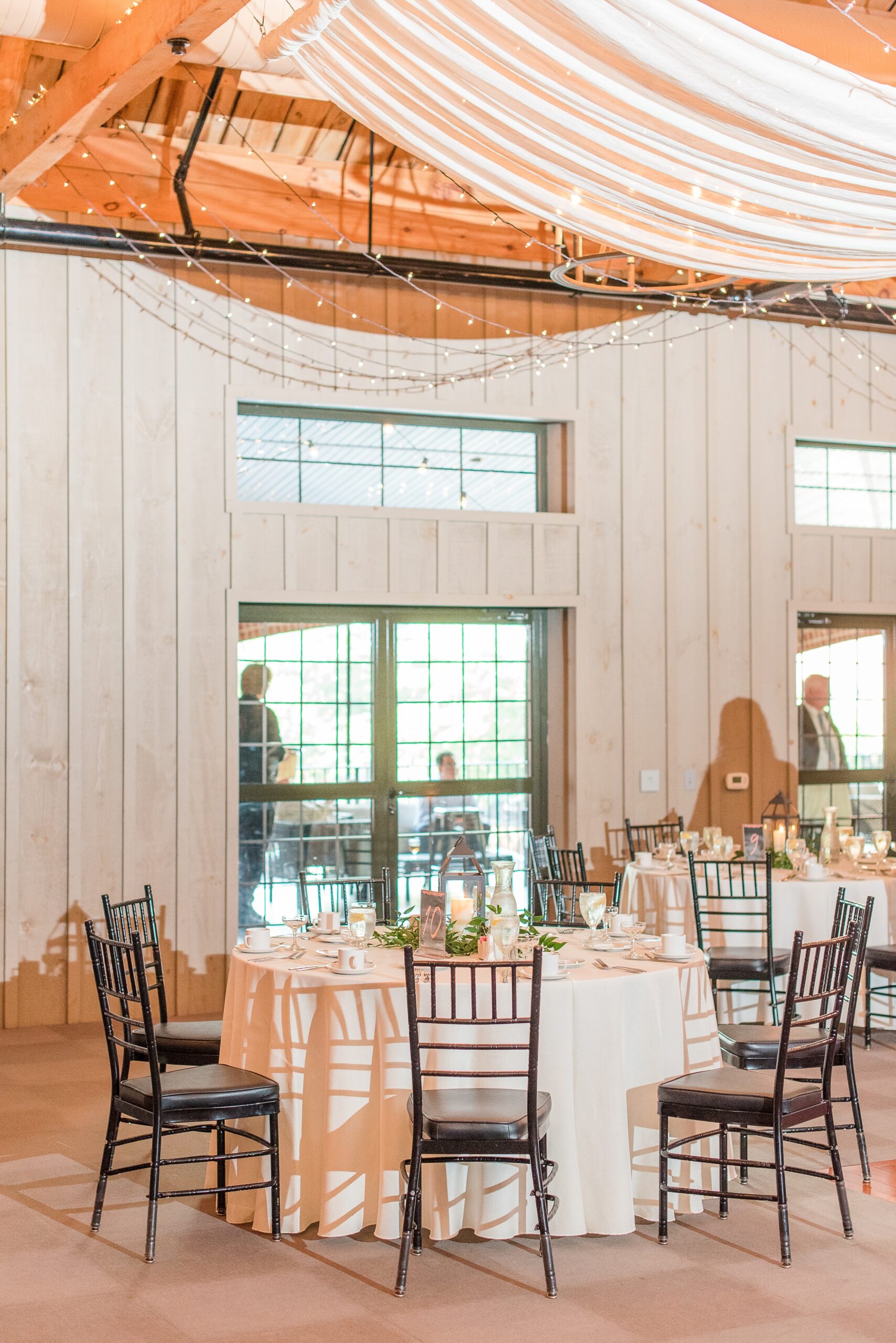 Details of a wedding reception table under string lights