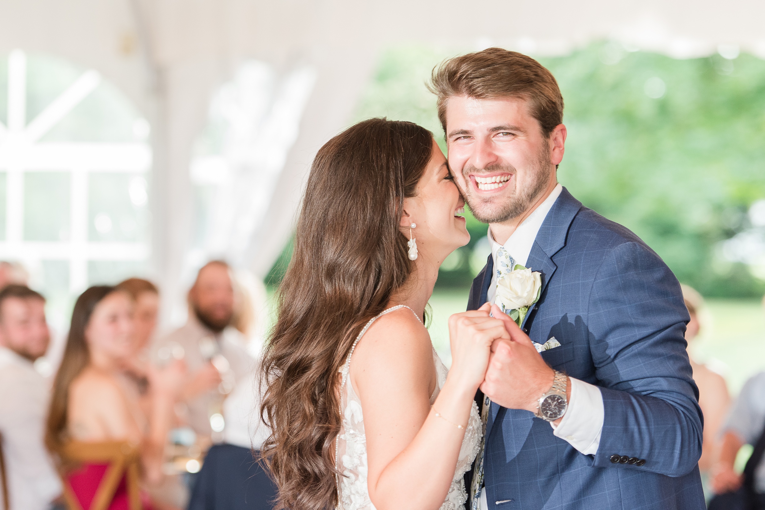 Newlyweds laugh while dancing for the first time during their wedding reception