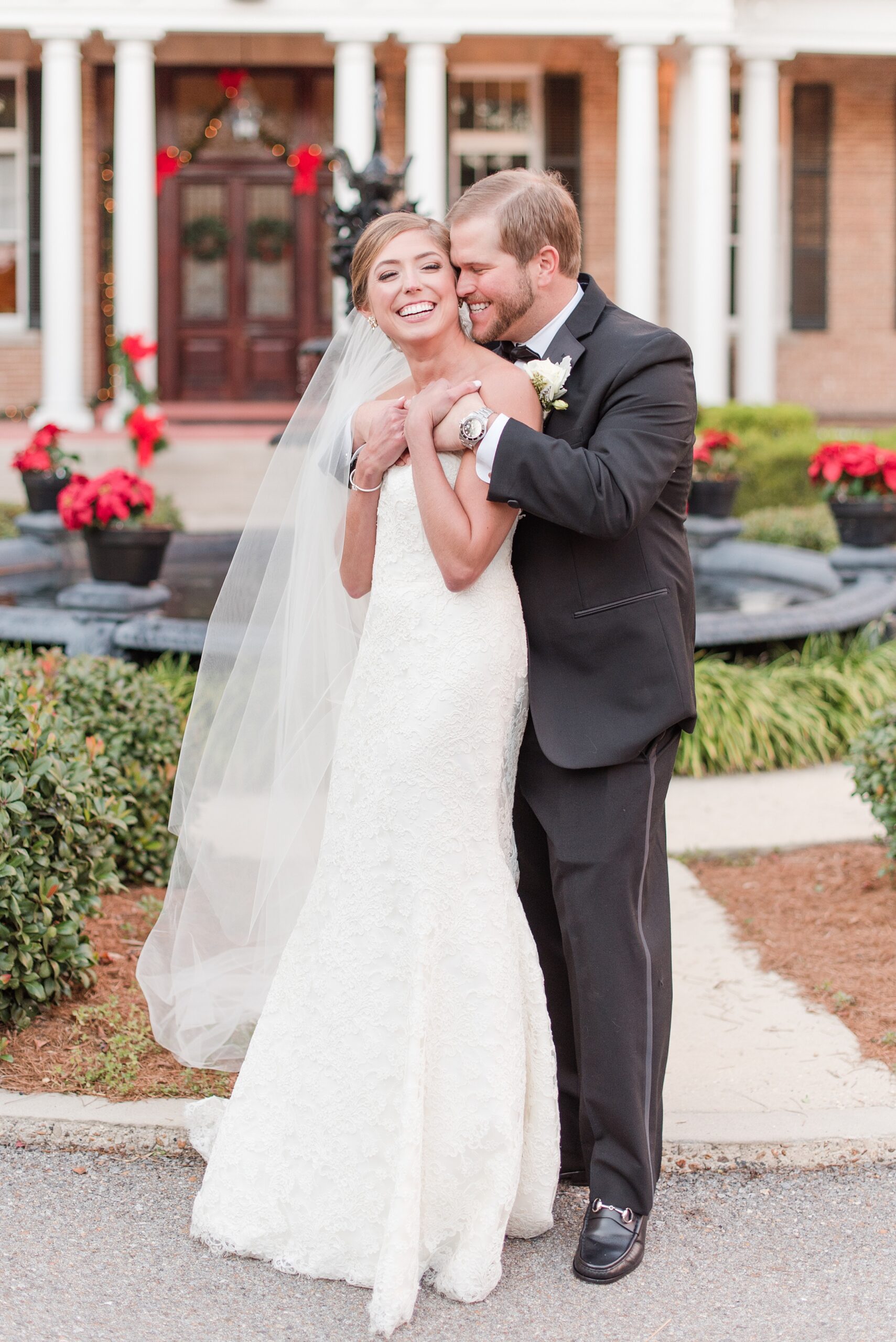 Newlyweds laugh while hugging in a garden after trusting Annapolis Wedding Planners