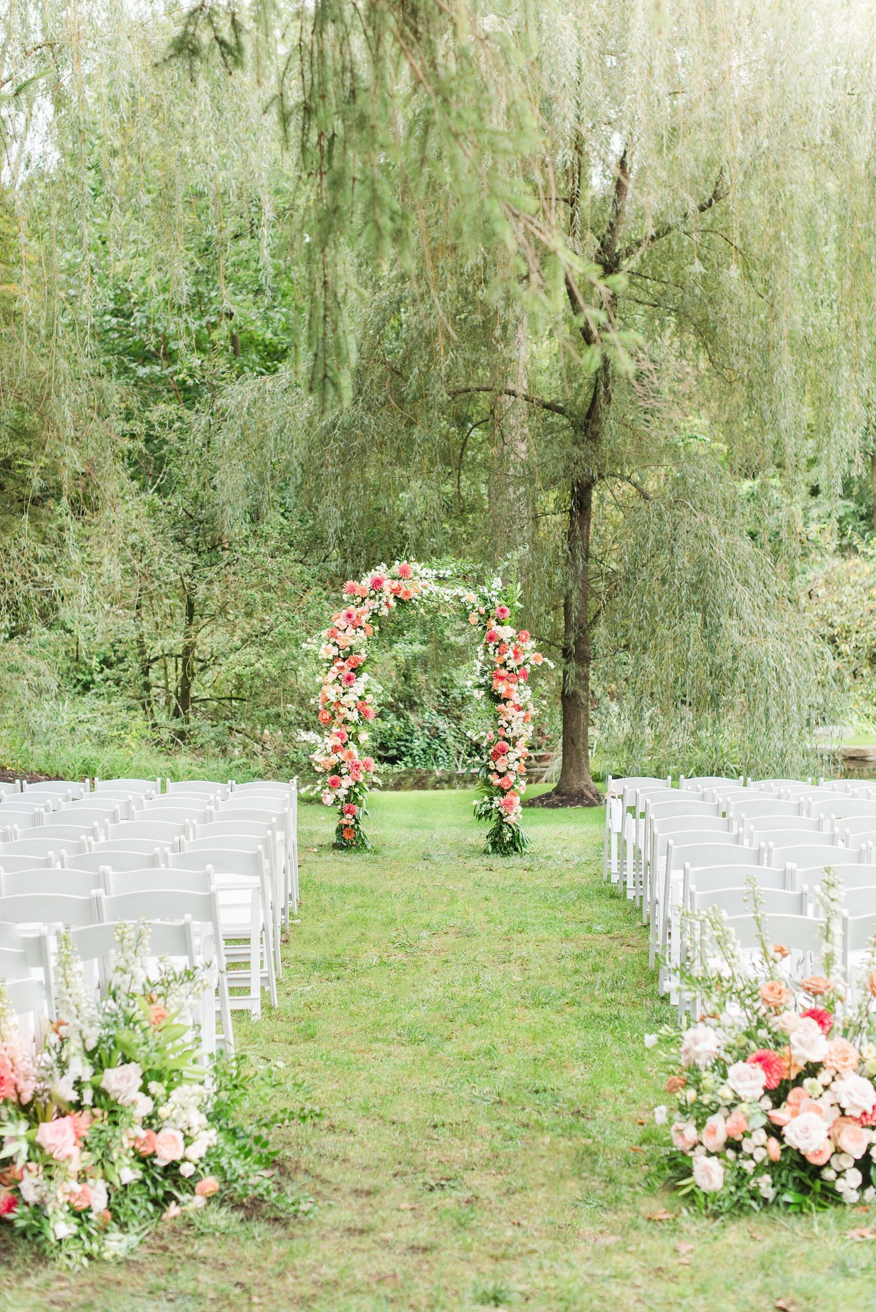 A view of an outdoor wedding ceremony under a willow tree at one of the Annapolis Wedding Venues