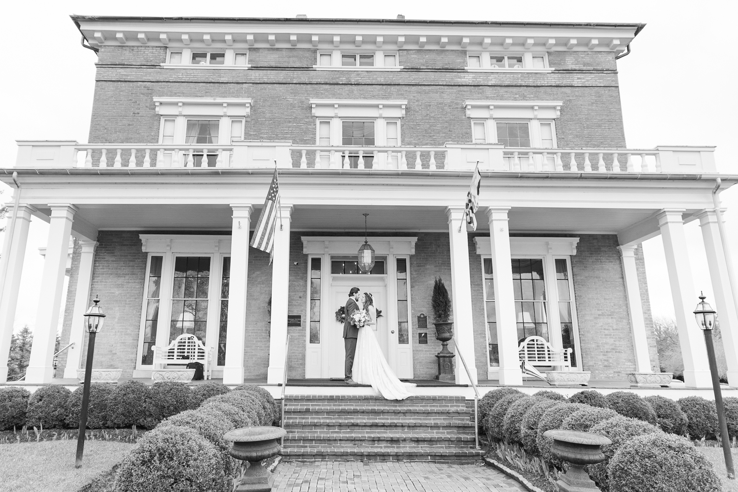 Newlyweds share a quiet moment on the front porch of the Antrim 1844 Wedding venue