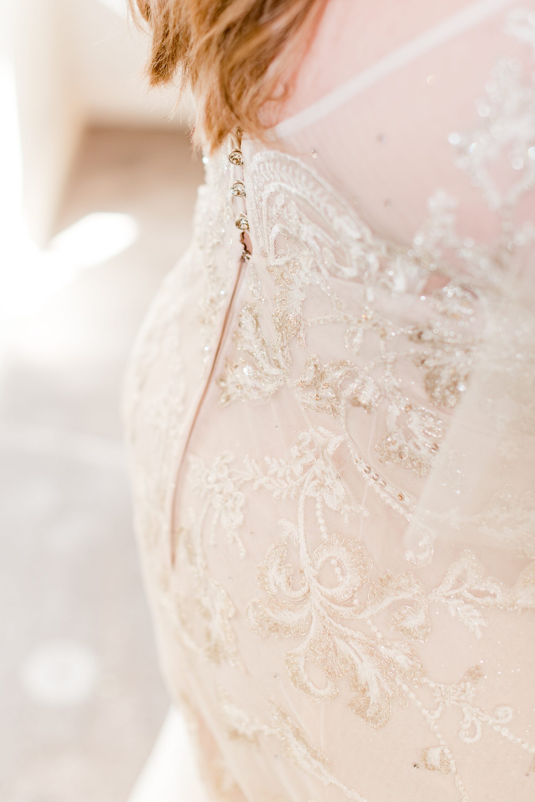 Details of a bride's ornate lace dress back