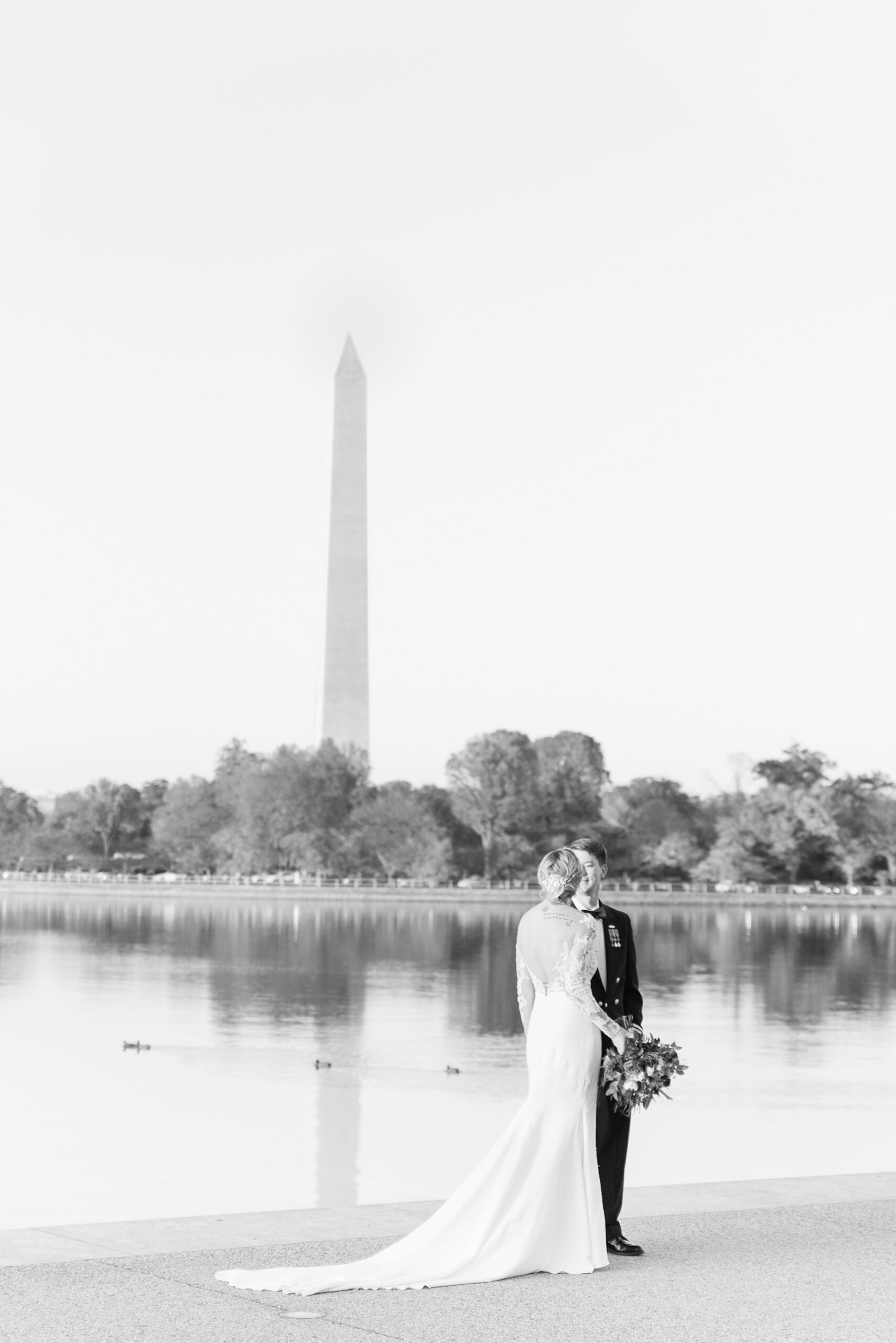 Newlyweds walk through the park along the water