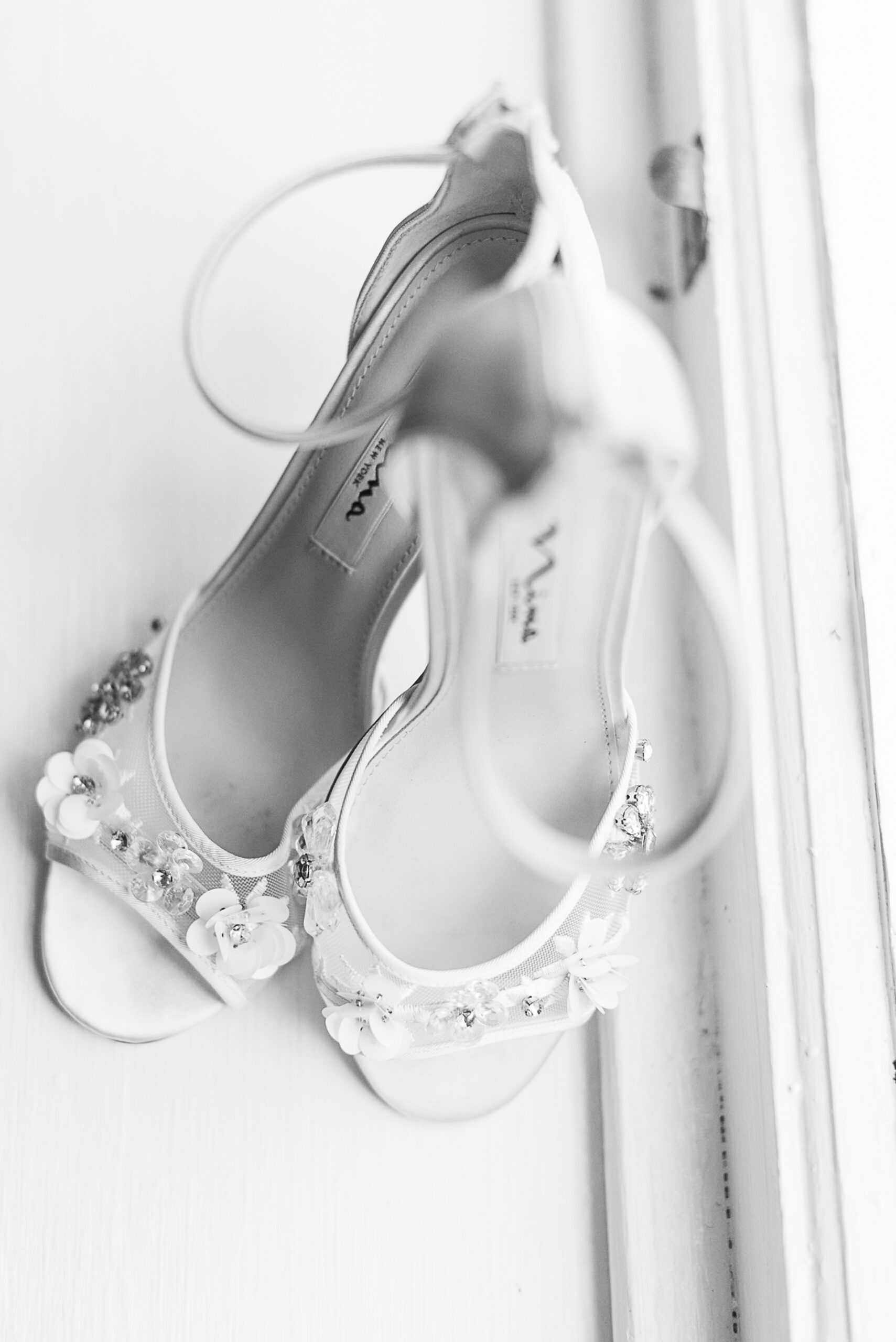 Details of a bride's shoes sitting in a window sill