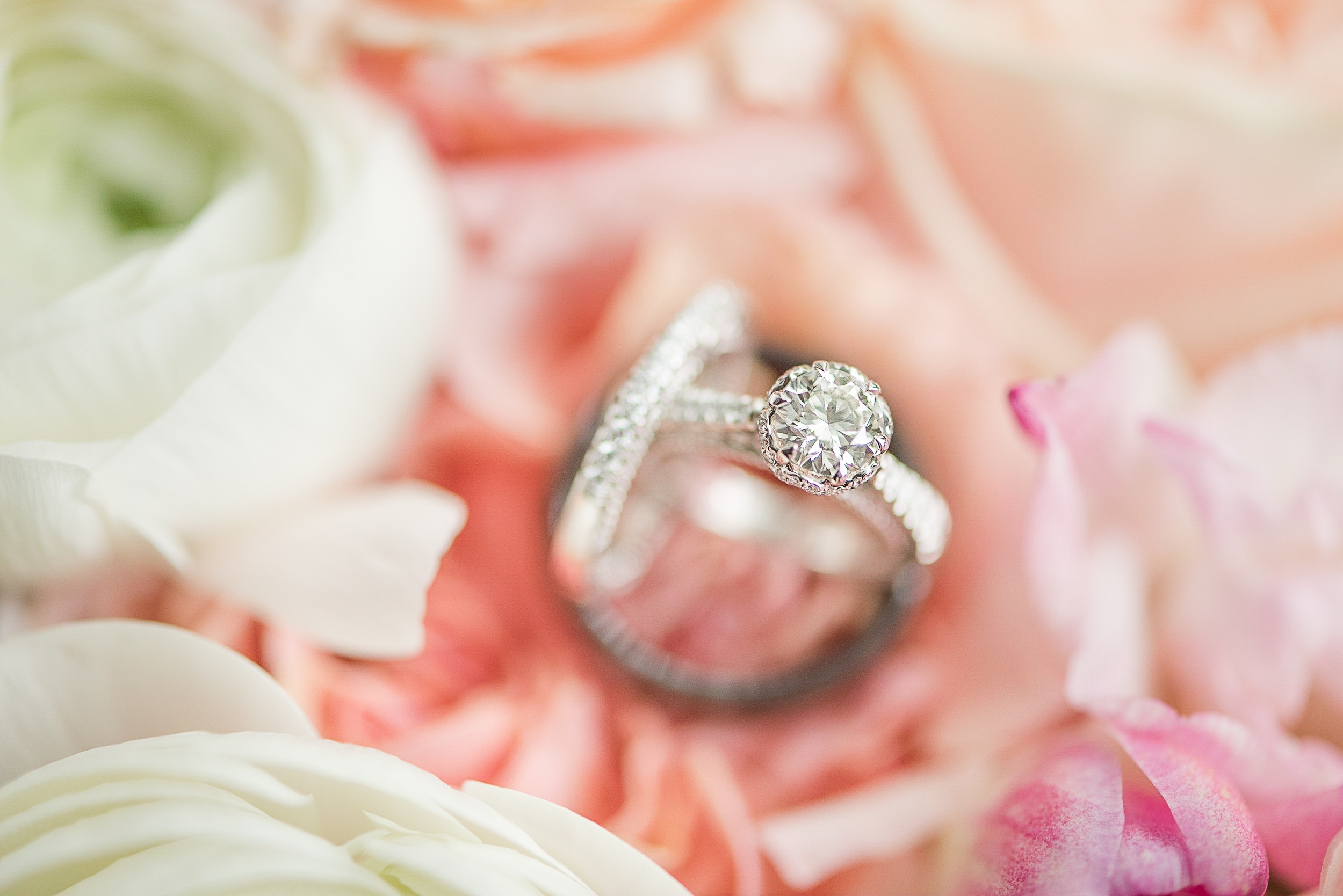 Details of wedding rings standing on flowers