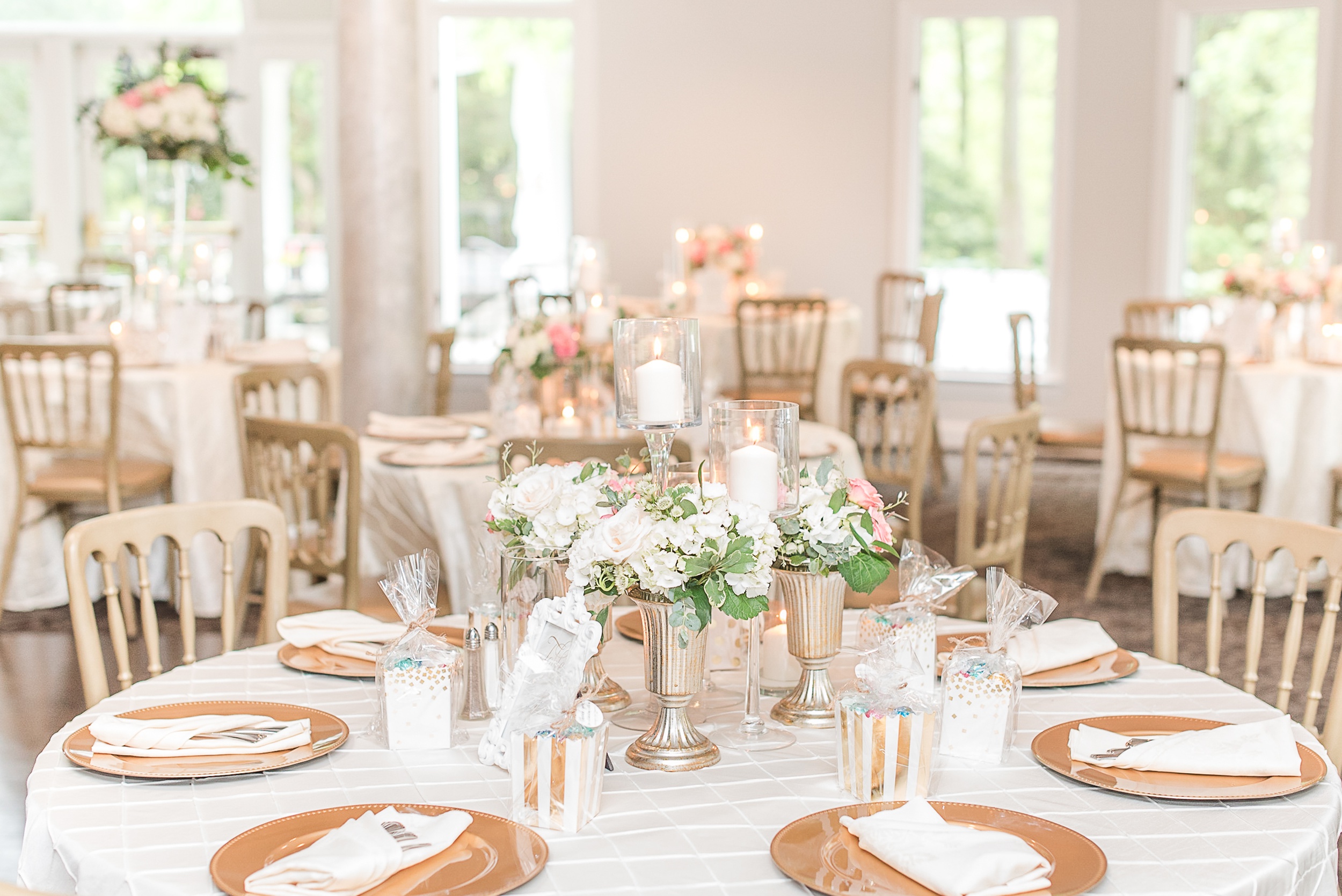 Details of a Ceresville Mansion Wedding reception table with candles, florals and gold chargers