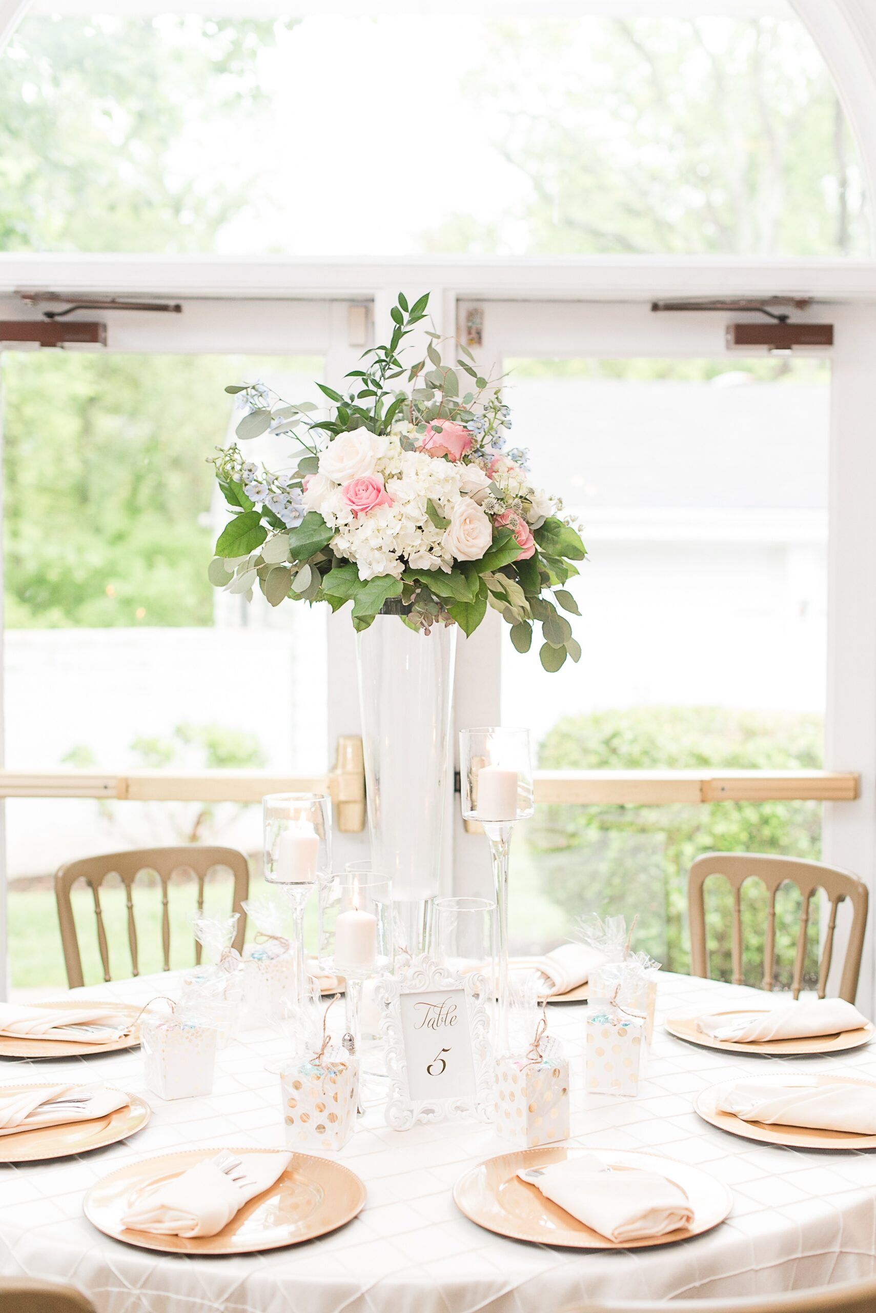 Details of a wedding reception table with tall vase of flowers at a Ceresville Mansion Wedding