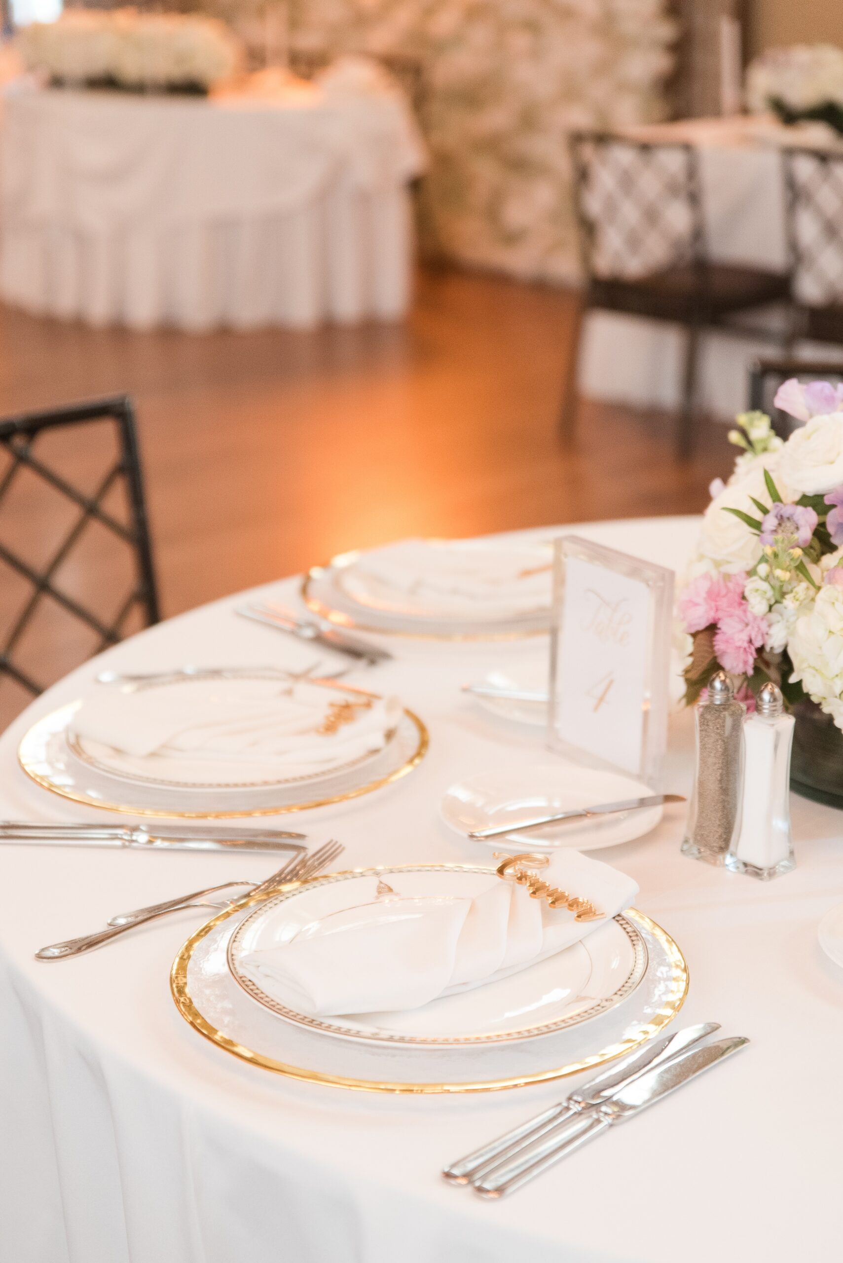Details of a Congressional Country Club Wedding reception place setting with gold rimmed dishes