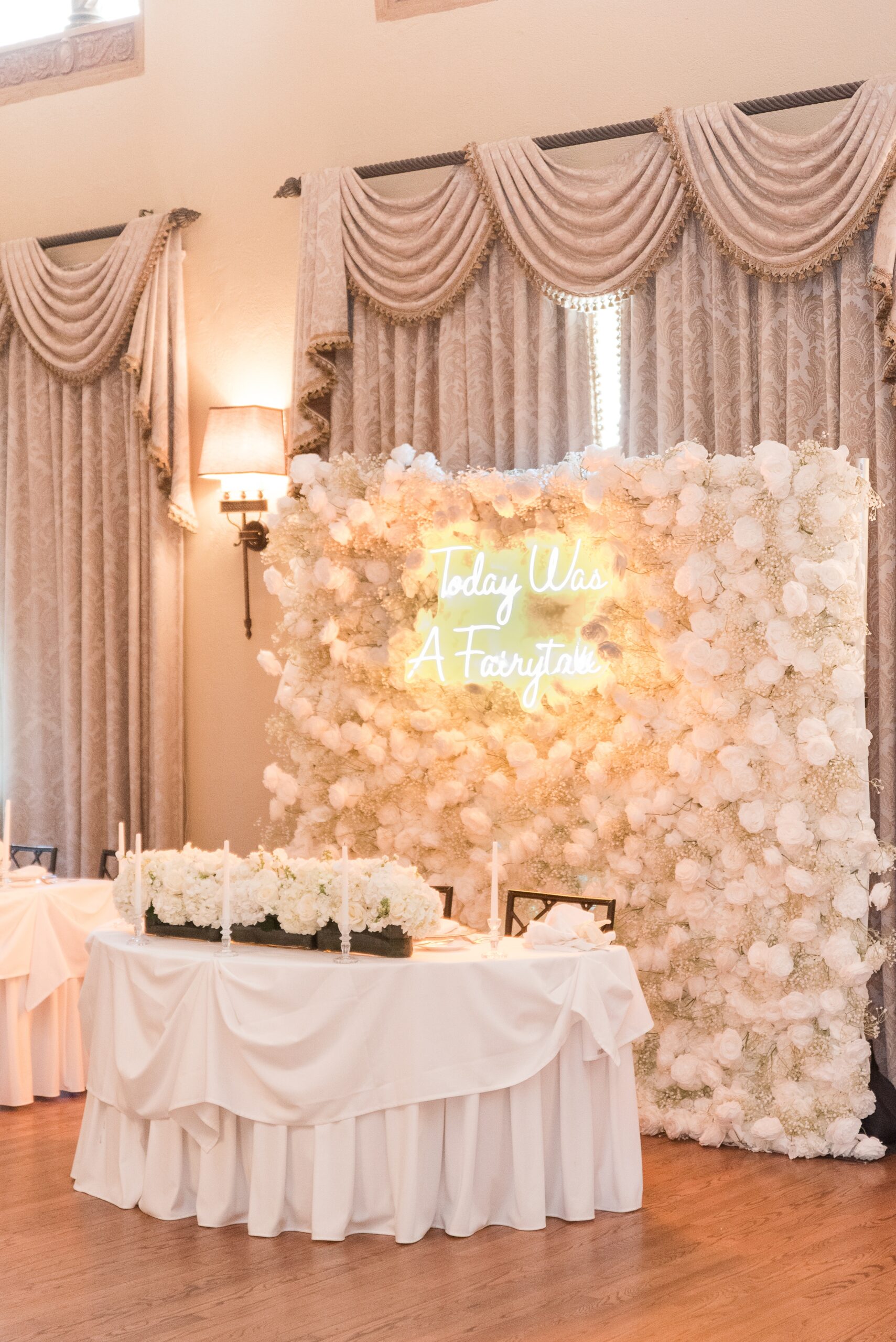 Details of a flower wall behind a Congressional Country Club Wedding reception head table with custom led lights