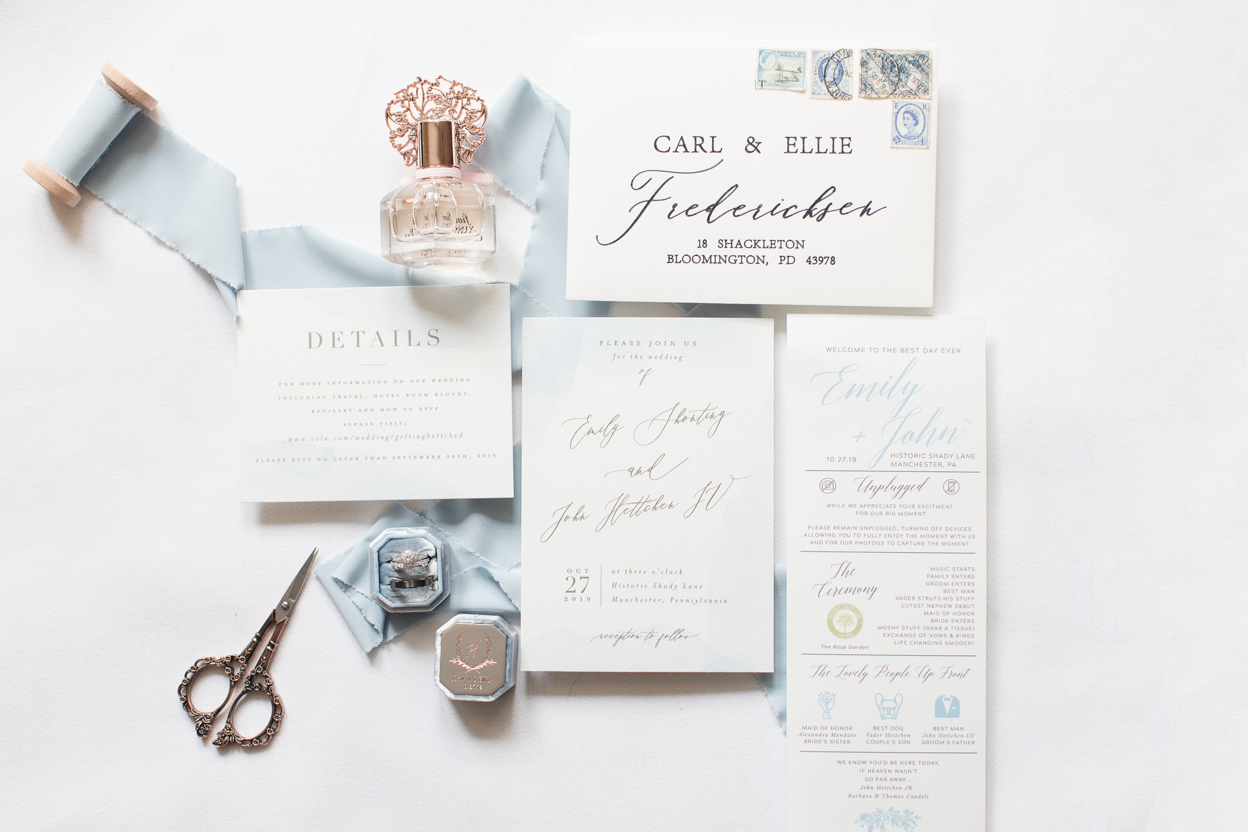 Details of wedding invitations and bridal details laying on a table