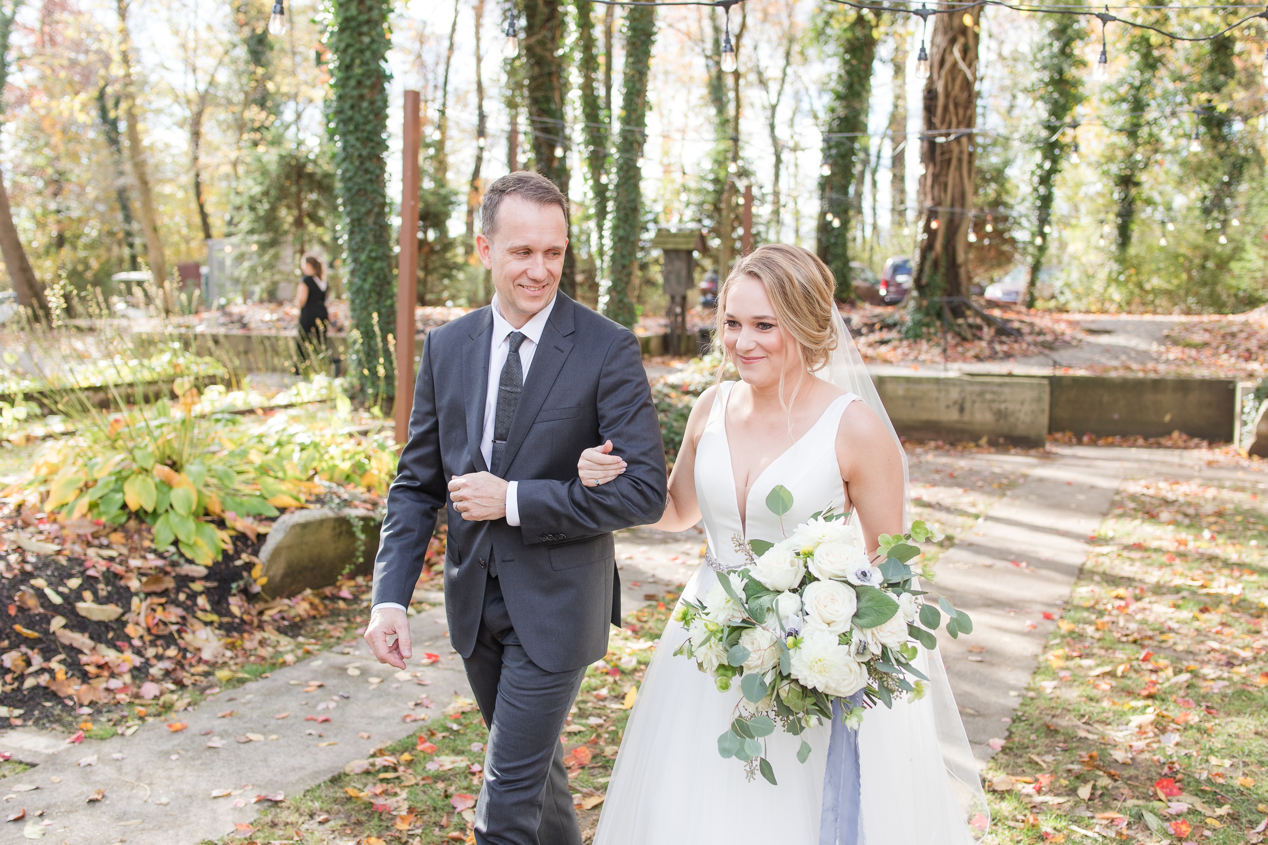 A father smiles while walking his daughter down the aisle at her Historic Shady Lane Wedding