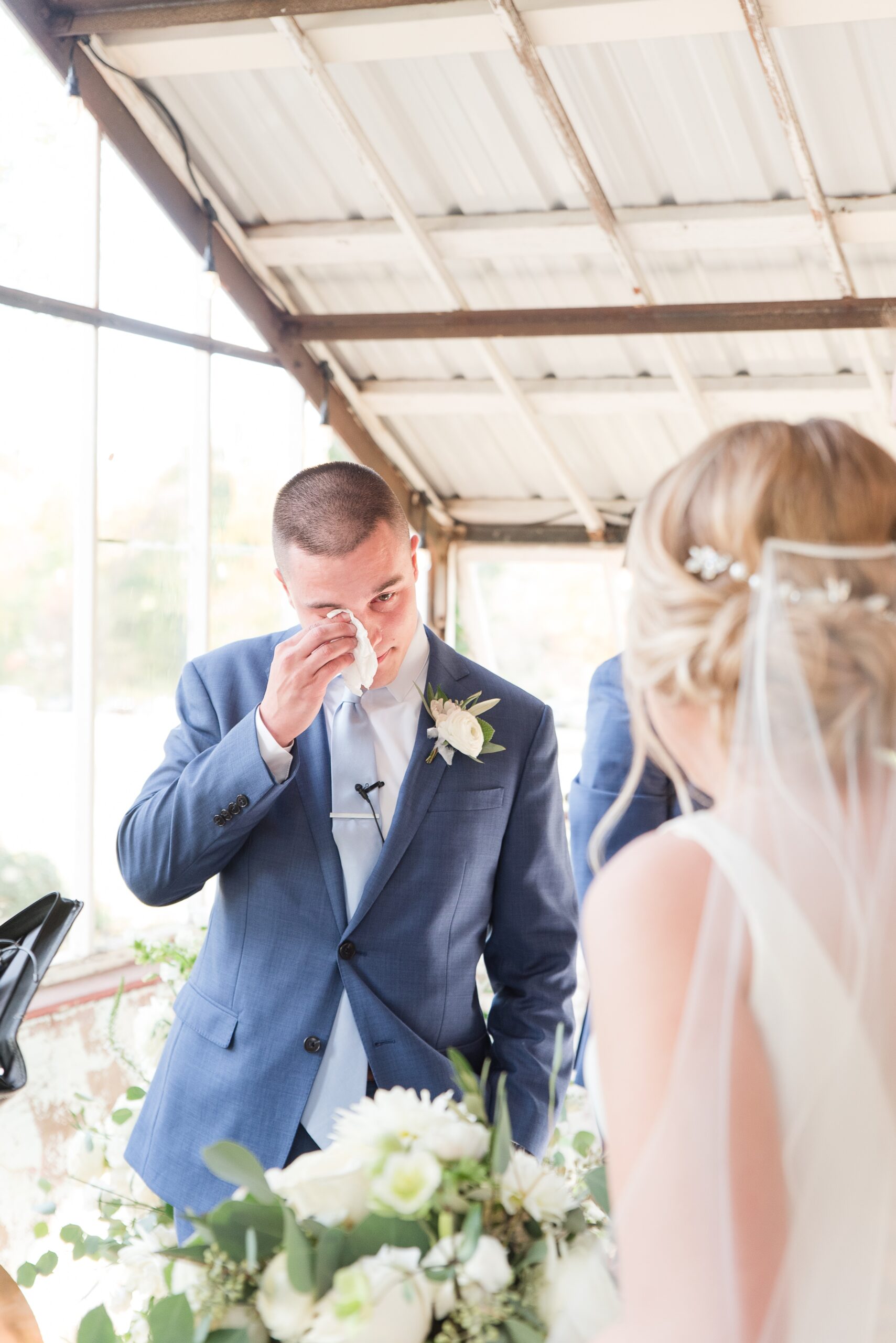 A groom cries at the altar while seeing his bride