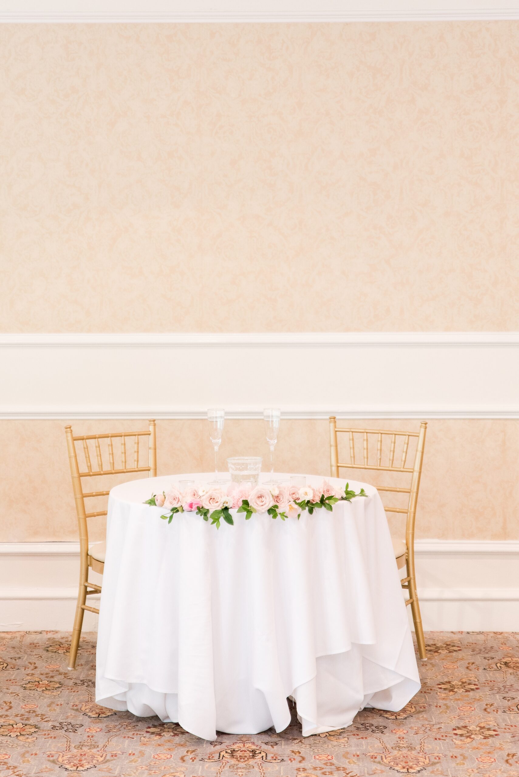Details of a Manor Country Club Wedding reception head table with pink roses and white linen