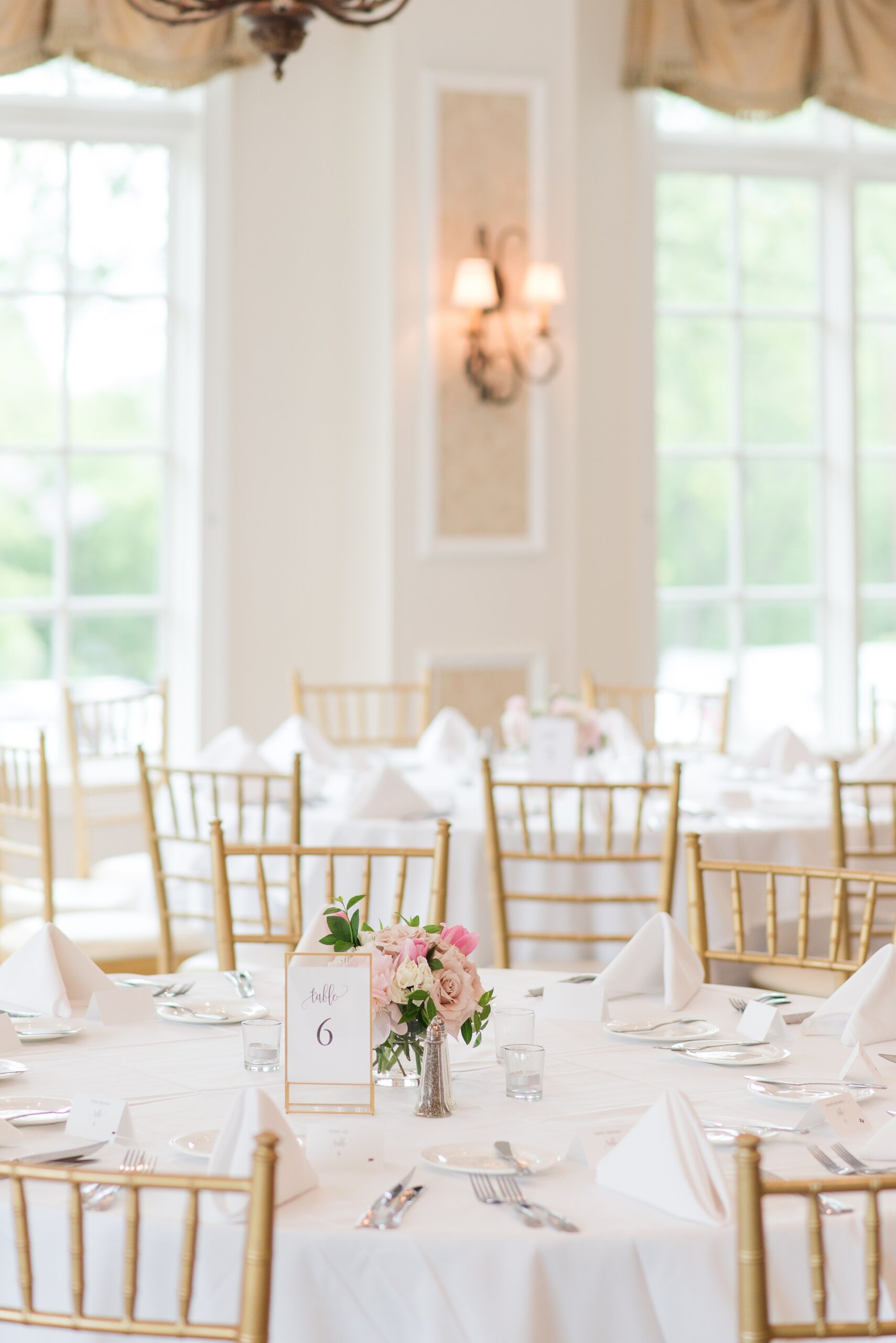 Details of a Manor Country Club Wedding reception with gold chairs, white linens and napkins