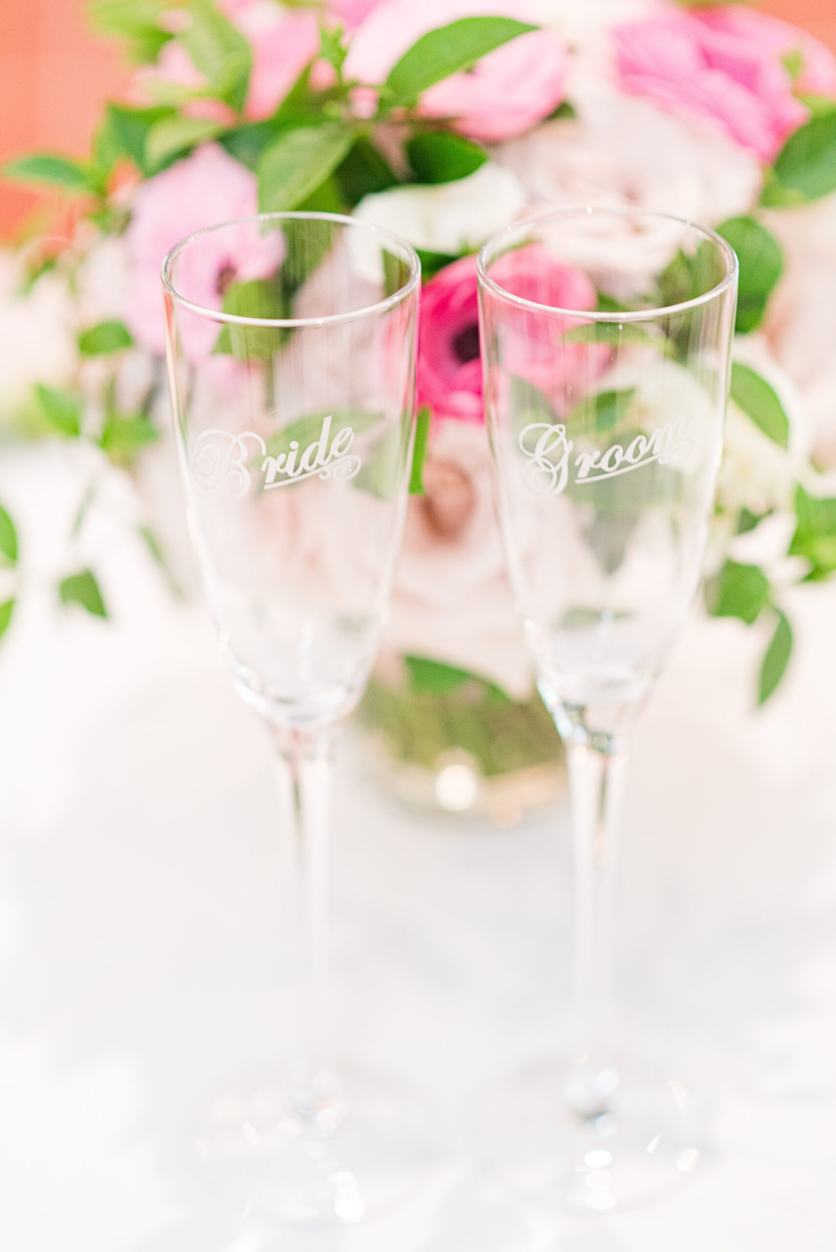 Details of bride and groom glasses on a table