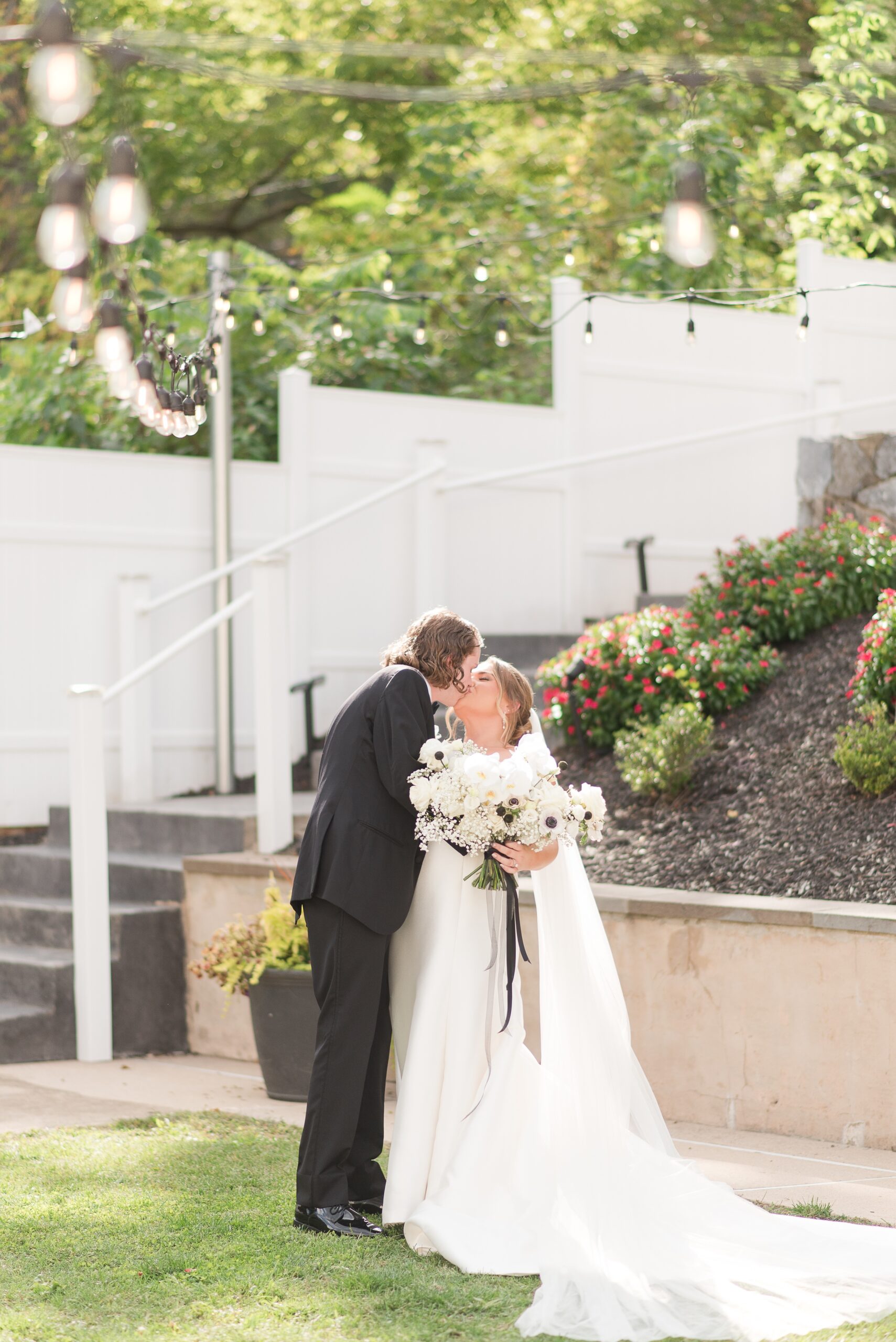 Newlyweds share a kiss in the gardens of the Milton Ridge Wedding venue