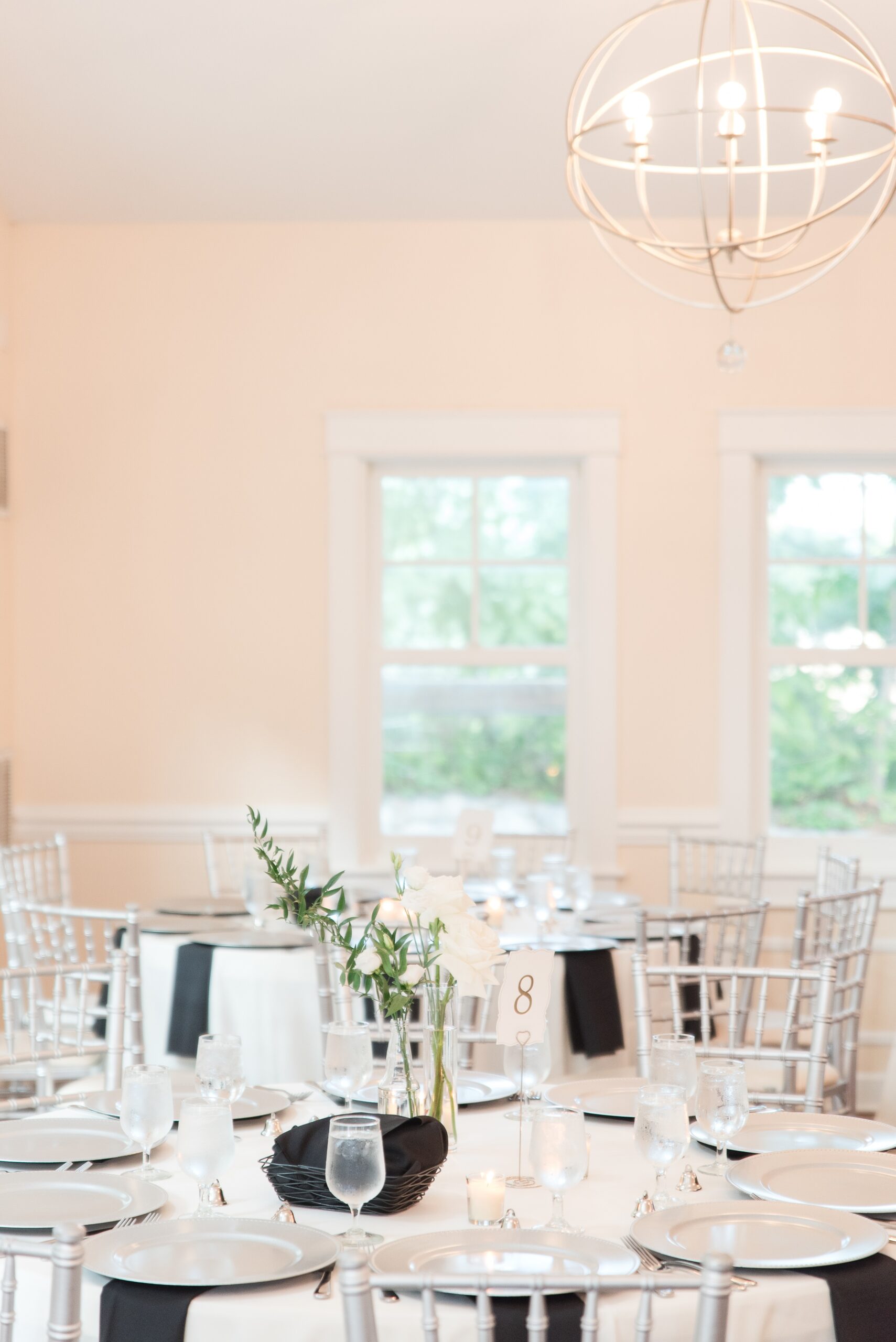 Details of a wedding reception table set up with black napkins and white linens at a Milton Ridge Wedding