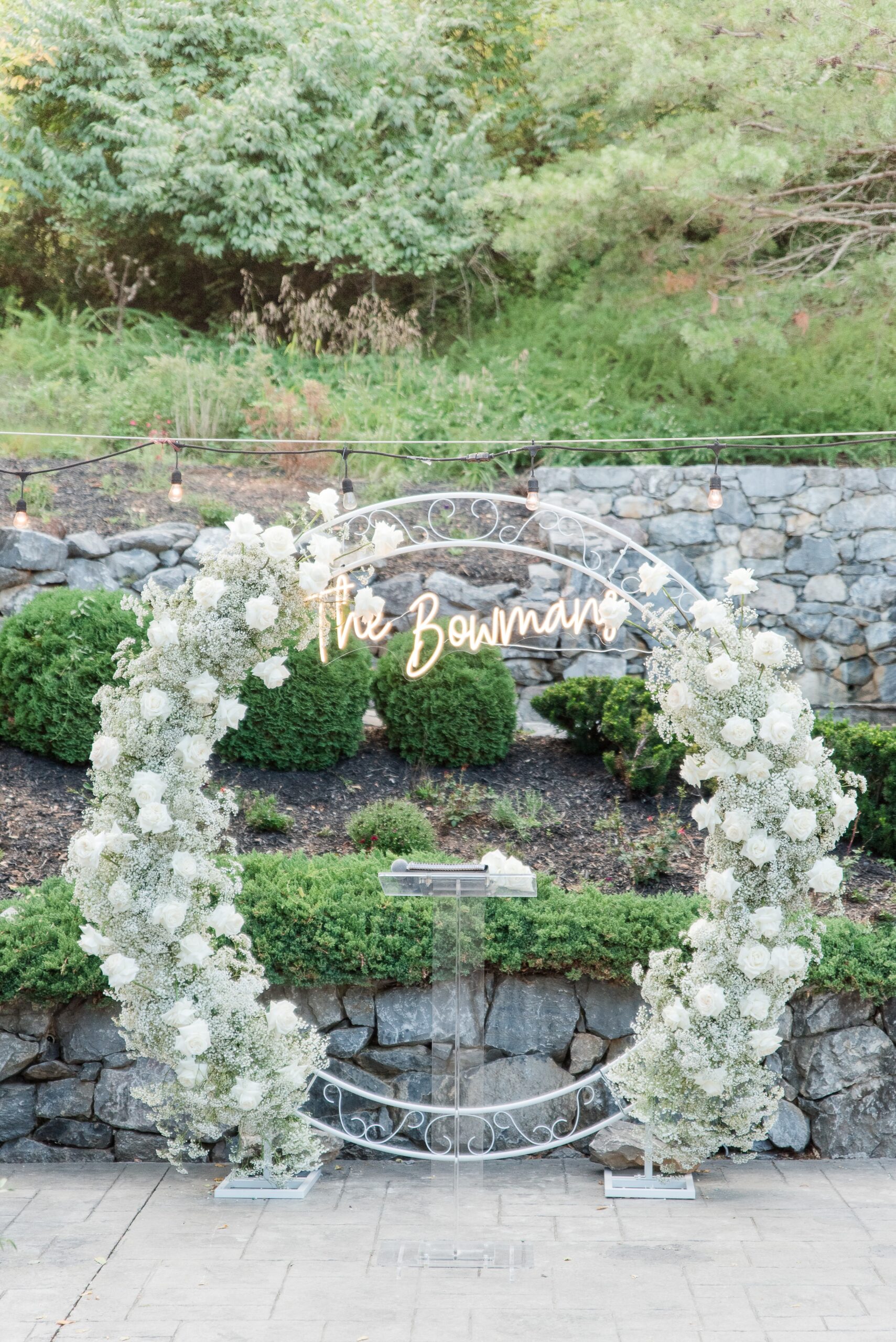 Details of a floral arch with custom led sign at an outdoor Milton Ridge Wedding