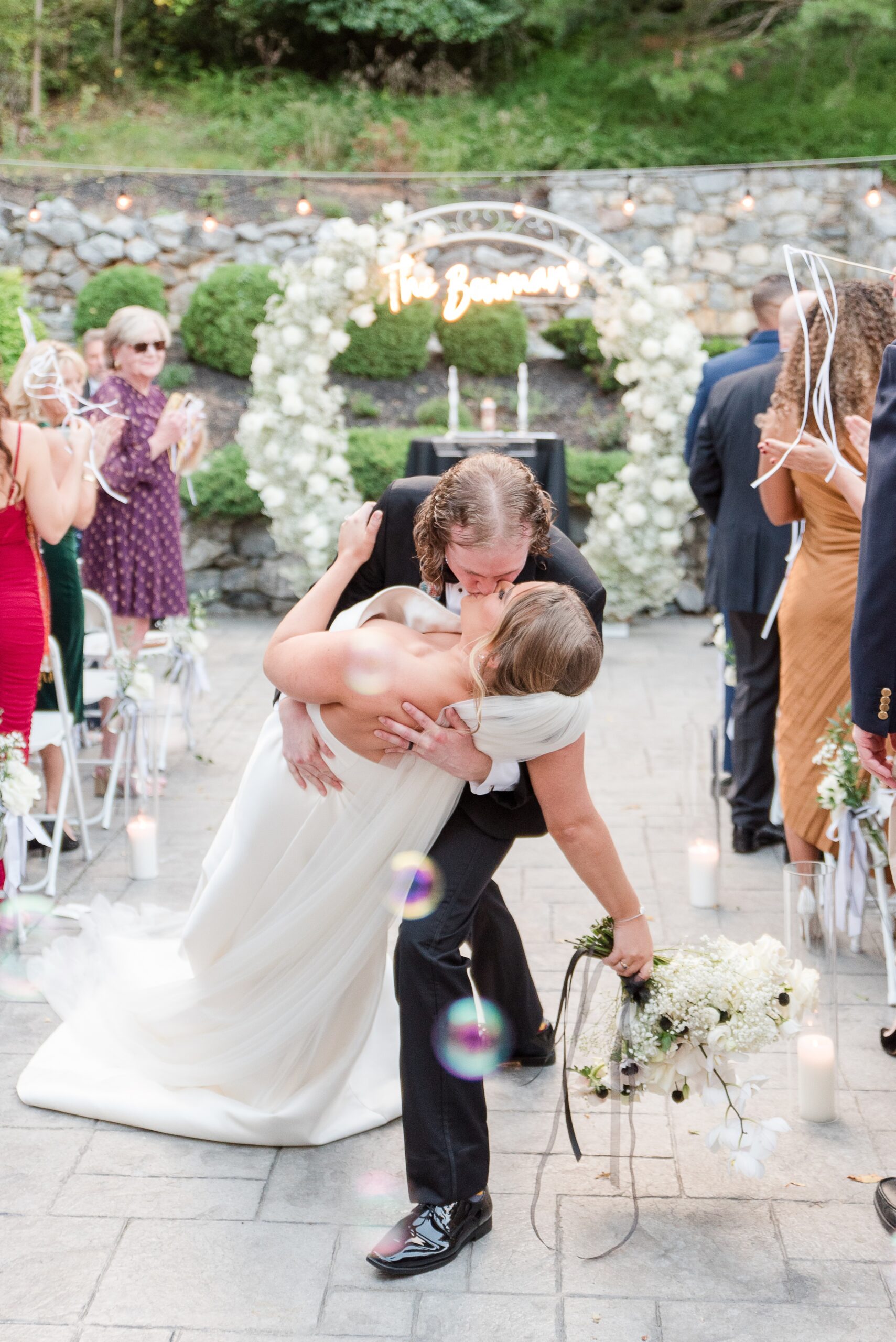 A groom dips his bride in the aisle for a kiss to end their Milton Ridge Wedding ceremony