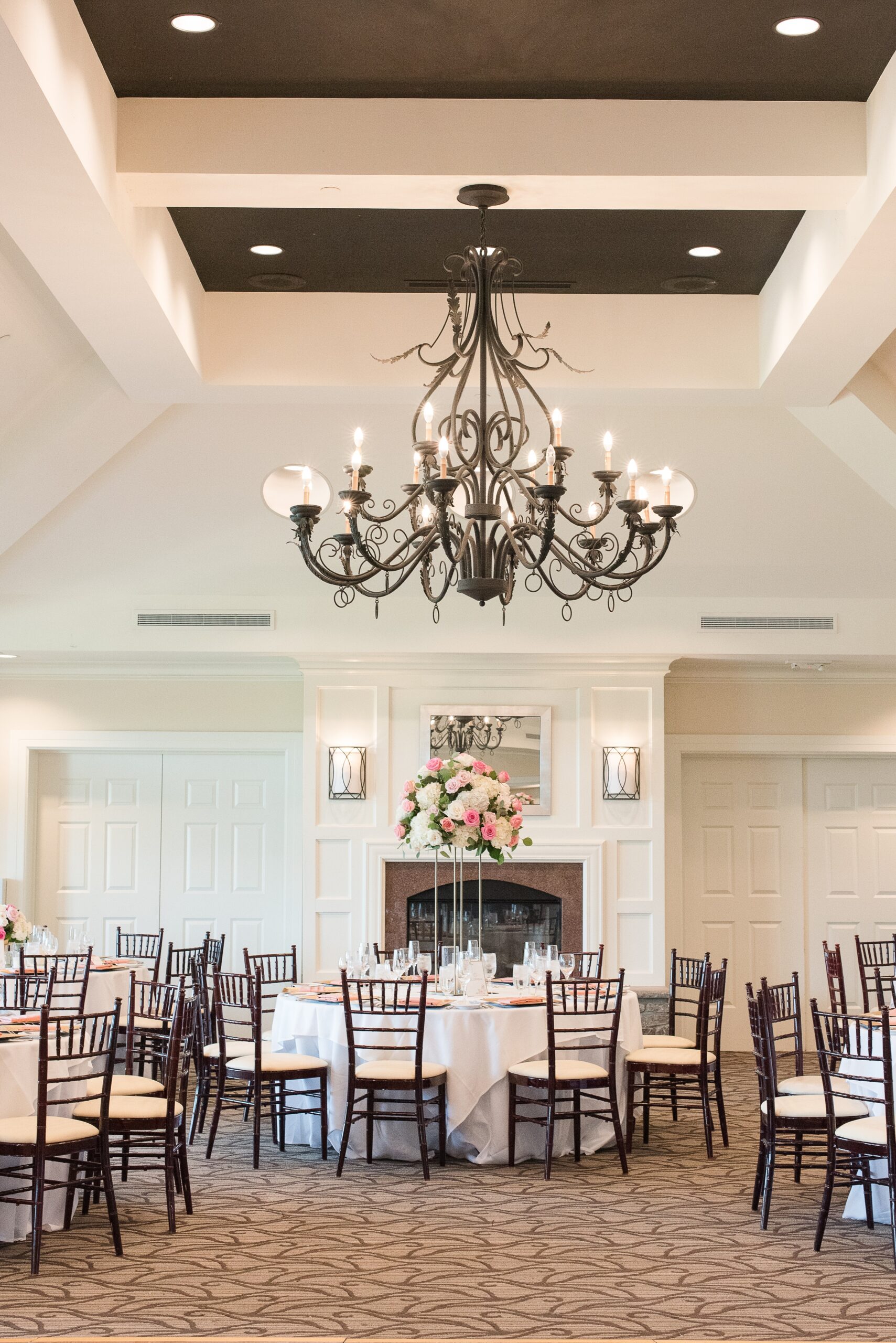 A view of the chandelier hangin above a wedding reception set up at the River Creek Club Wedding venue