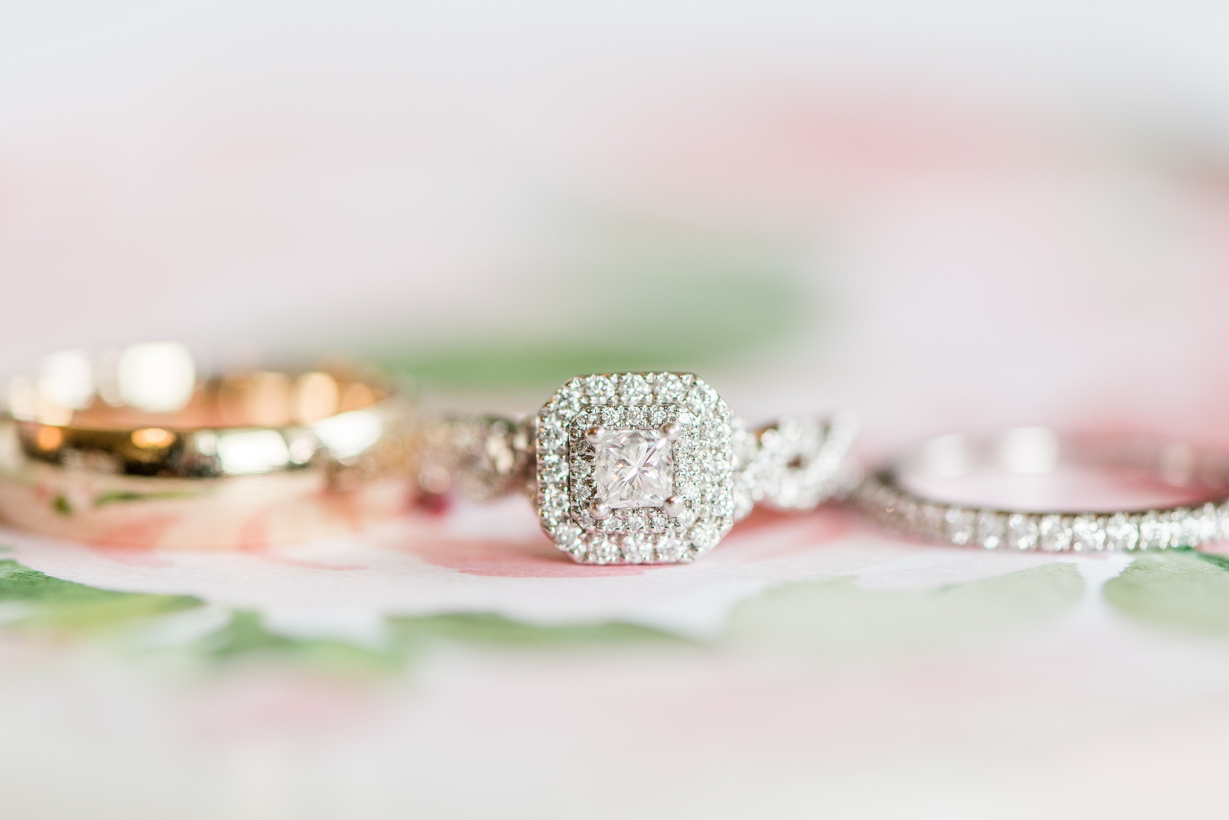 Details of a wedding engagement ring sitting on a table