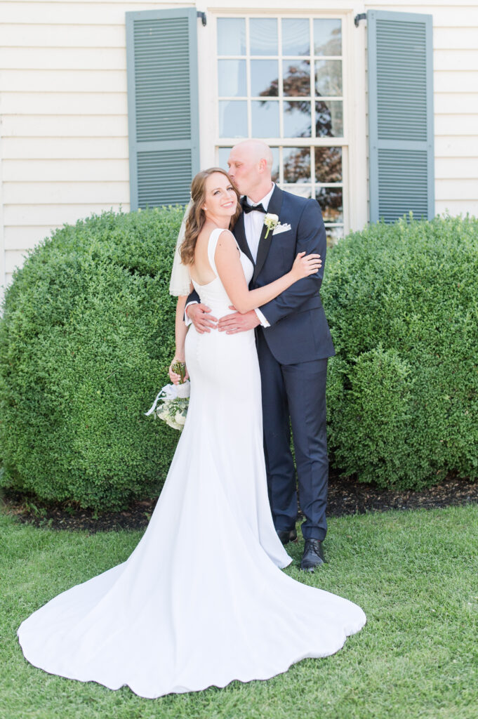 married couple in front of osprey point inn