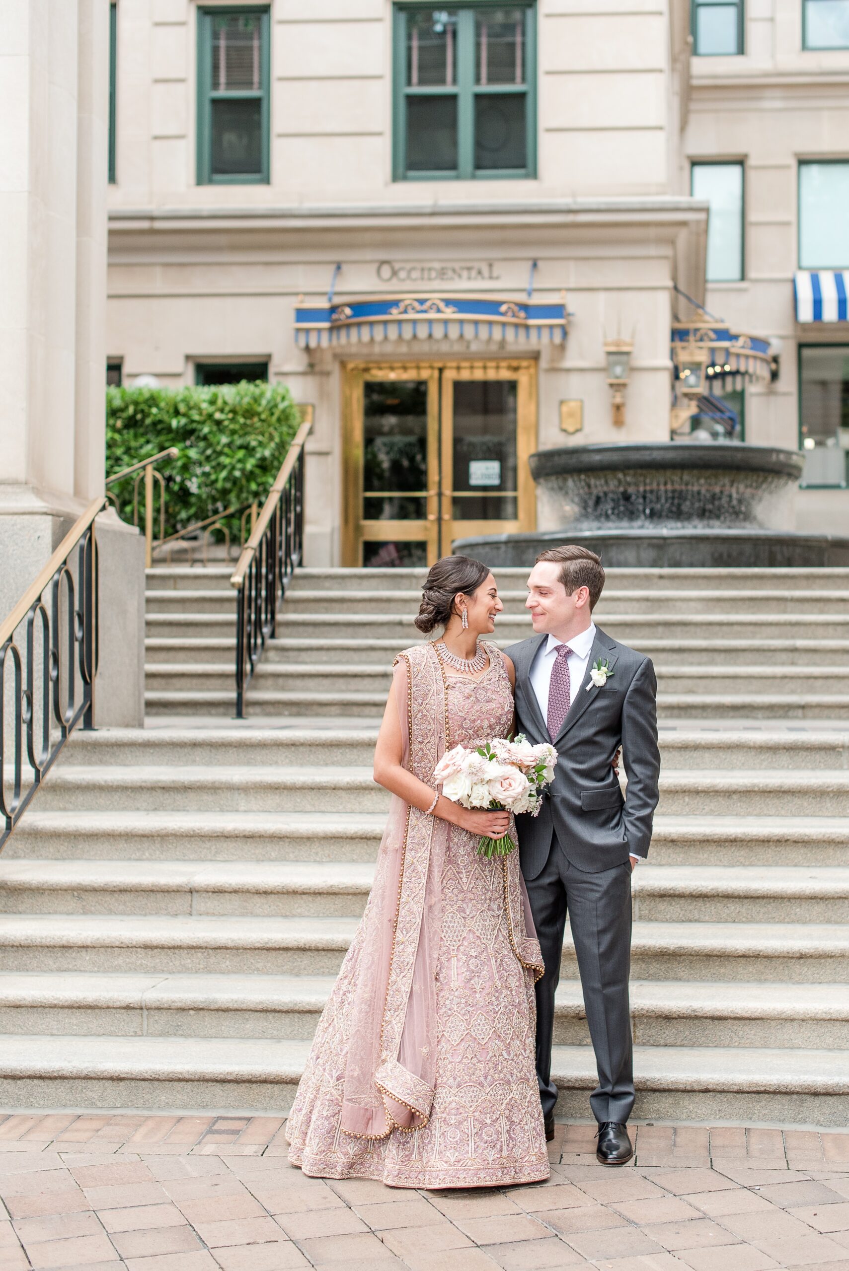 Newlyweds walk and laugh while exploring the patio area