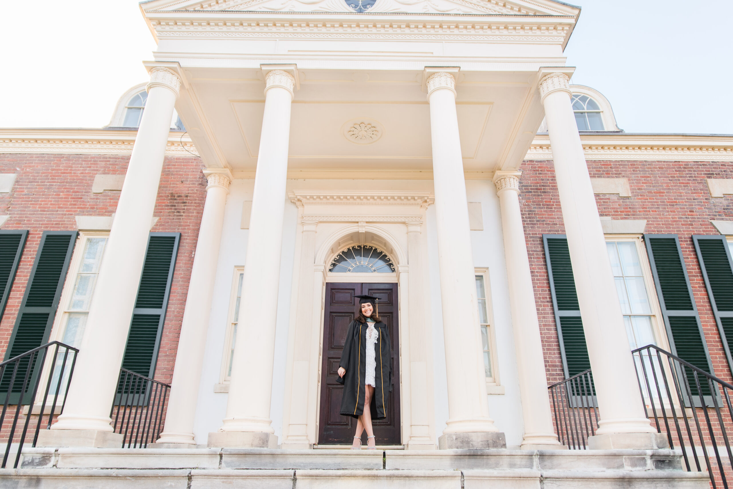 John Hopkins graduation photo white dress and black regalia master's degree