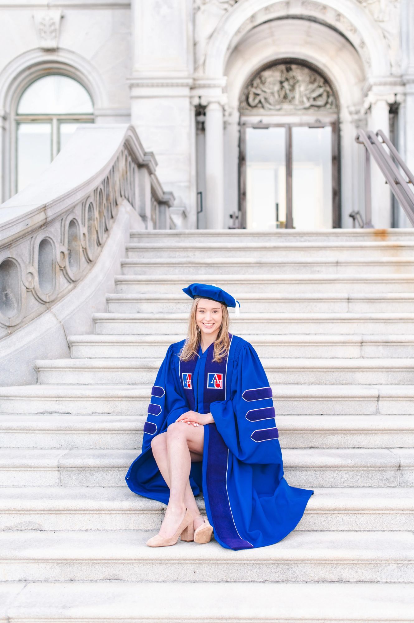 American University Graduate on the steps of the Library of Congress sitting down