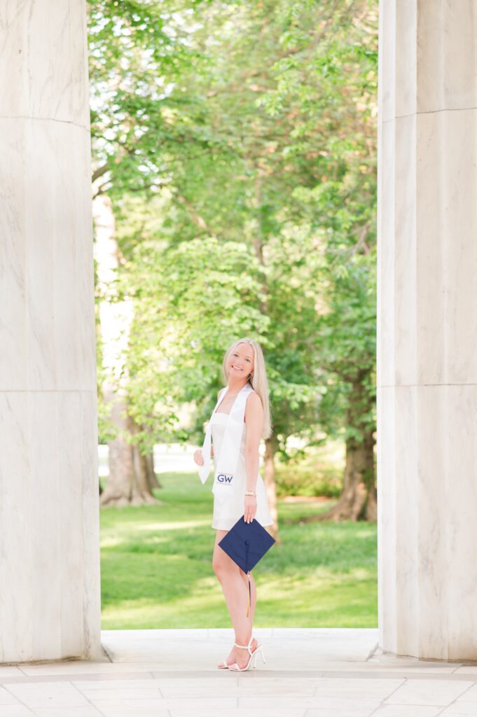 GW graduate in between war memorial columns